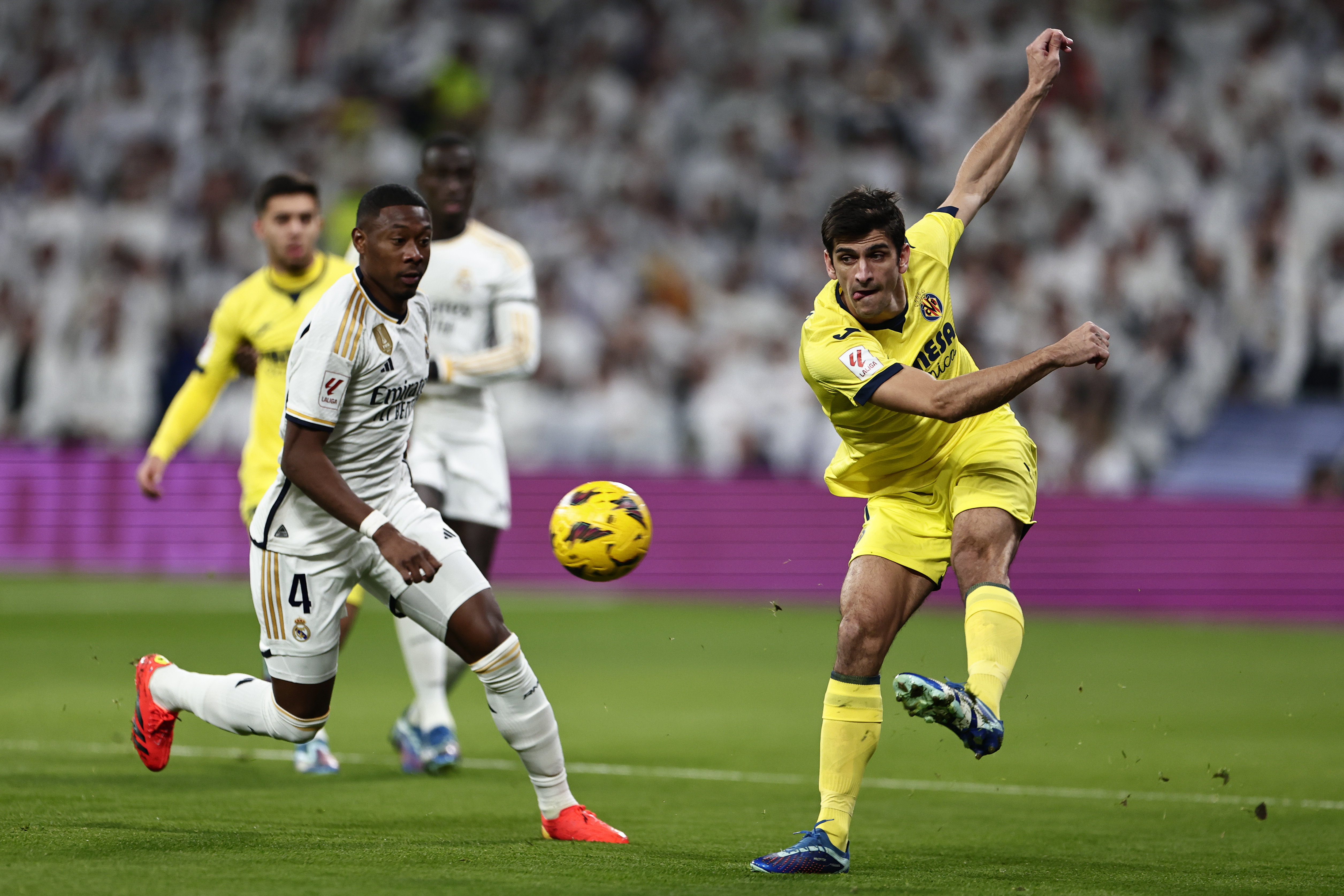 Villarreal's Gerard Moreno, right, clears the ball from Real Madrid's David Alaba during the Spanish La Liga soccer match between Real Madrid and Villarreal at the Santiago Bernebeu stadium in Madrid, Spain, Sunday, Dec. 17, 2023. (AP Photo/Pablo Garcia)