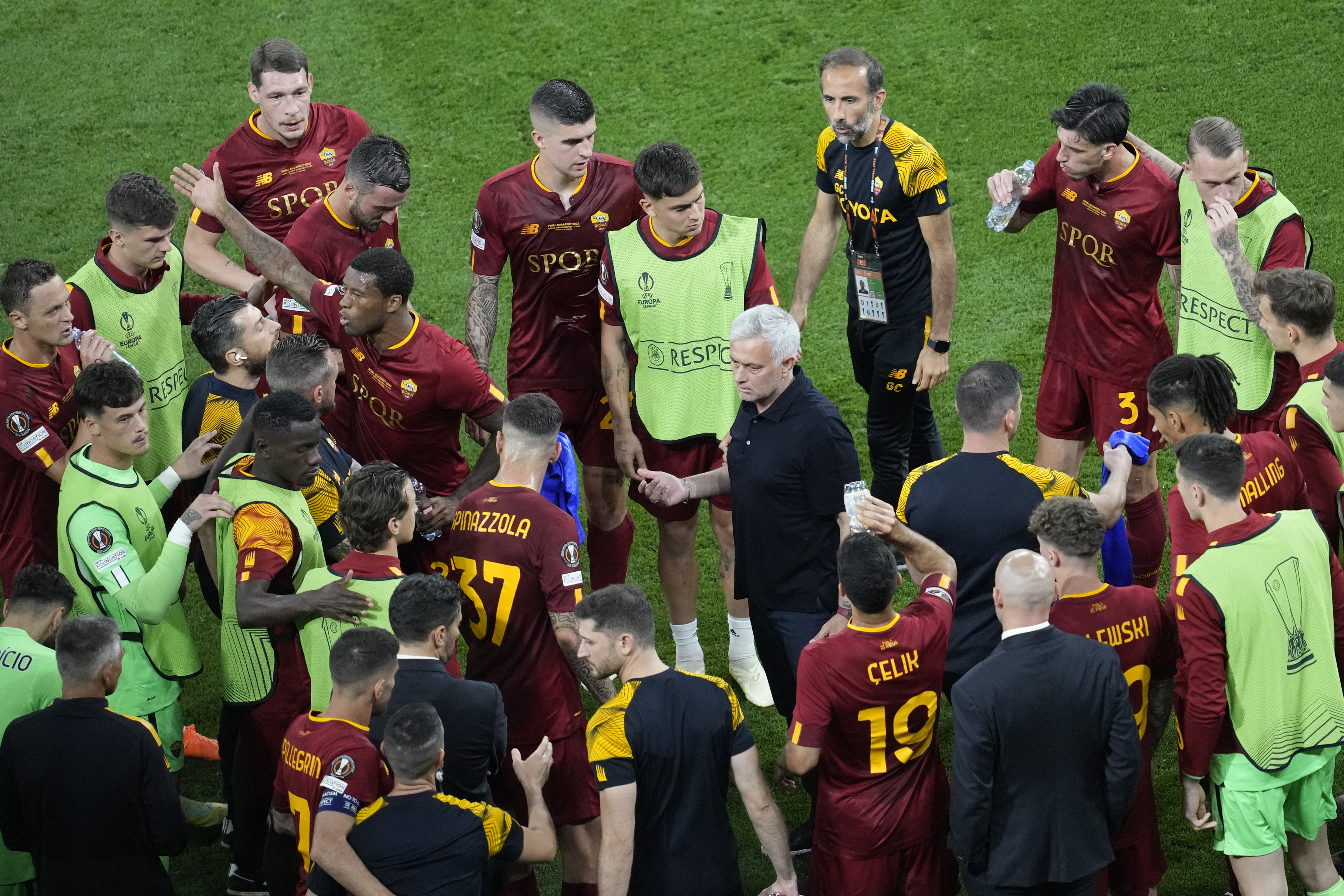 Roma's head coach Jose Mourinho talks to his players before the extra time, during the Europa League final soccer match between Sevilla and Roma, at the Puskas Arena in Budapest, Hungary, Wednesday, May 31, 2023. (AP Photo/Darko Vojinovic)