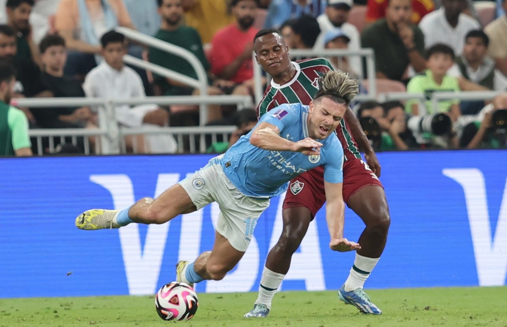 epa11041156 Manchester City's Jack Grealish (L) in action against Fluminense's Jhon Arias (R) during the FIFA Club World Cup 2023 final match between Manchester City and Fluminense FC in Jeddah, Saudi Arabia, 22 December 2023.  EPA-EFE/ALI HAIDER