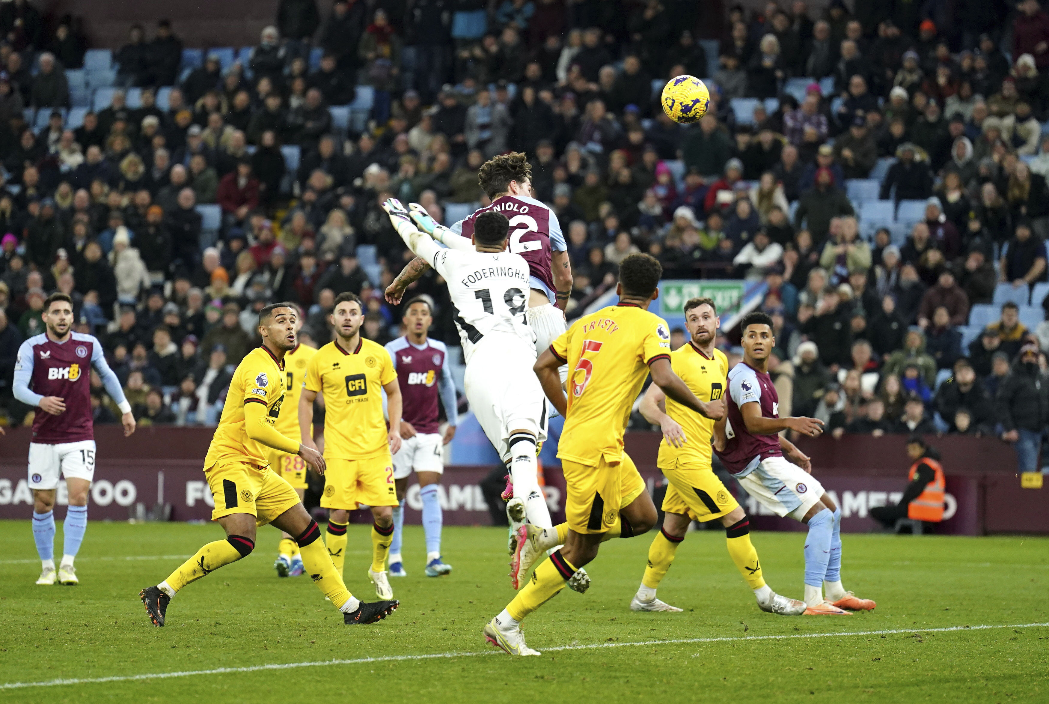 Aston Villa's Nicolo Zaniolo, top center, scores his sides first goal during the English Premier League soccer match between Aston Villa and Sheffield United at Villa Park in Birmingham, England, Friday, Dec. 22, 2023. (Mike Egerton/PA via AP)