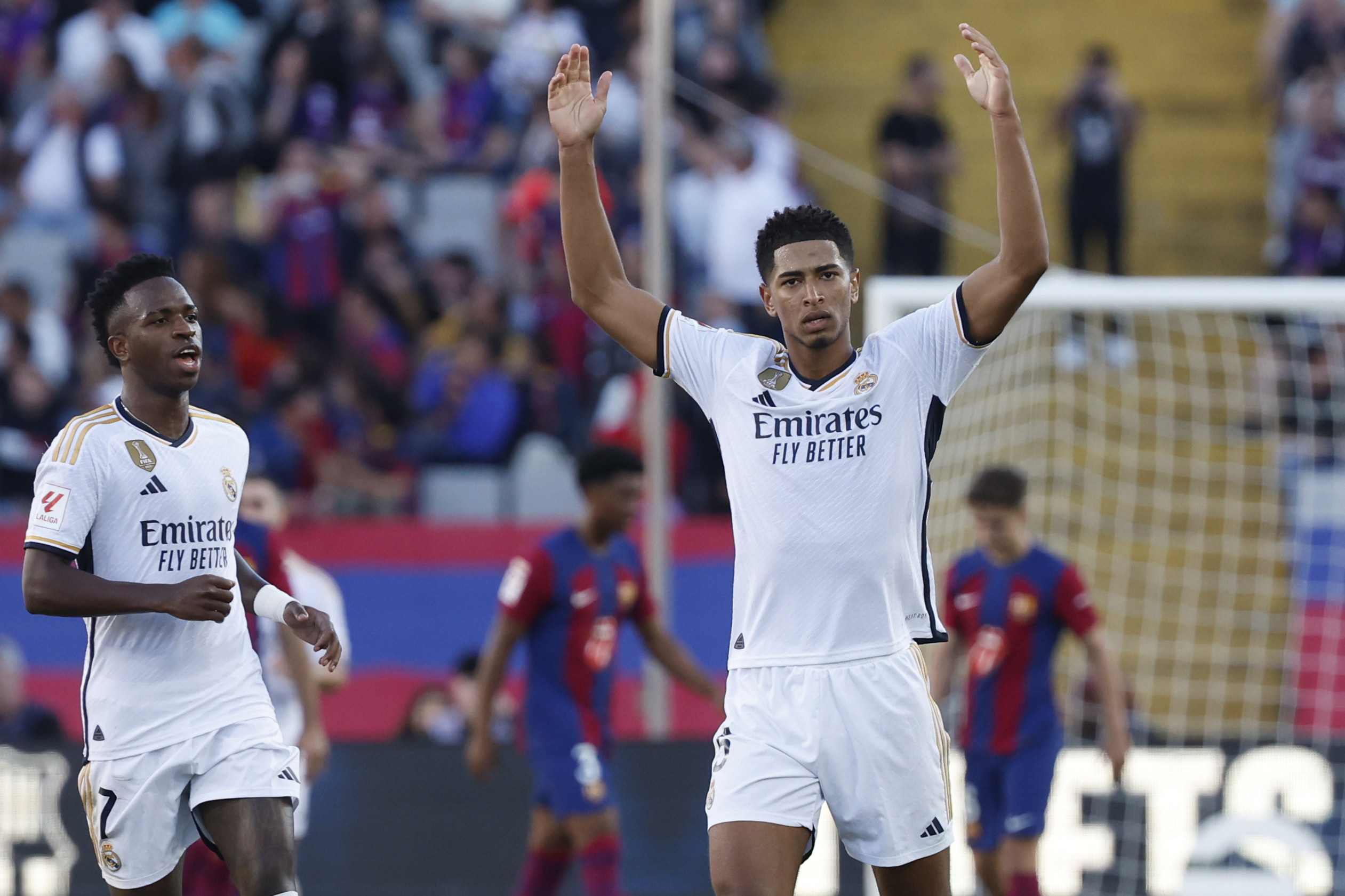 Real Madrid's Jude Bellingham, right, celebrates after scoring his side's opening goal during the La Liga soccer match between Barcelona and Real Madrid at the Olympic Stadium in Barcelona, Spain, Saturday, Oct. 28, 2023. (AP Photo/Joan Monfort)