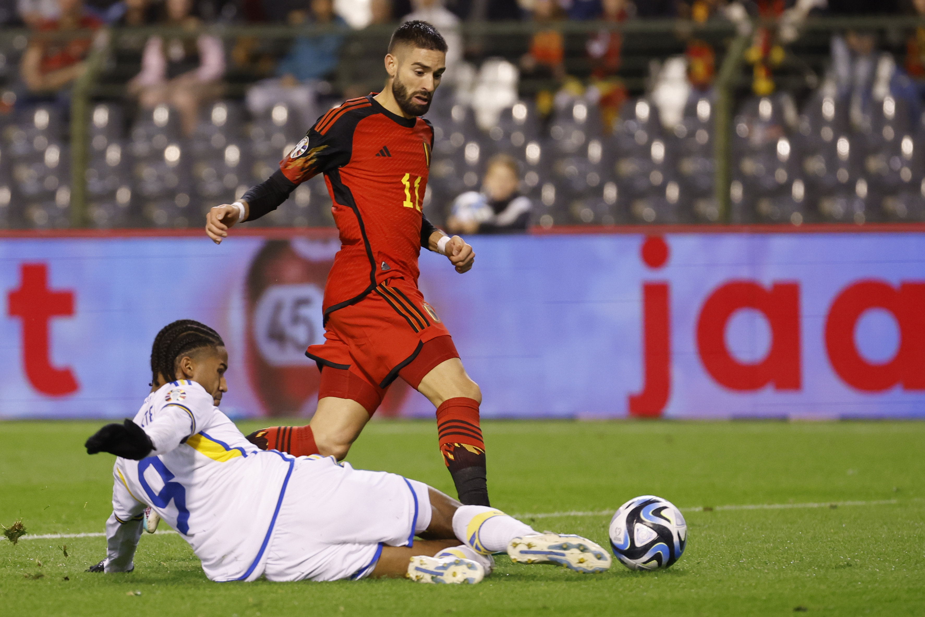 Belgium's Yannick Carrasco, top, is challenged by Sweden's Jens Cajuste during the Euro 2024 group F qualifying soccer match between Belgium and Sweden at the King Baudouin Stadium in Brussels, Monday, Oct. 16, 2023. (AP Photo/Geert Vanden Wijngaert)
