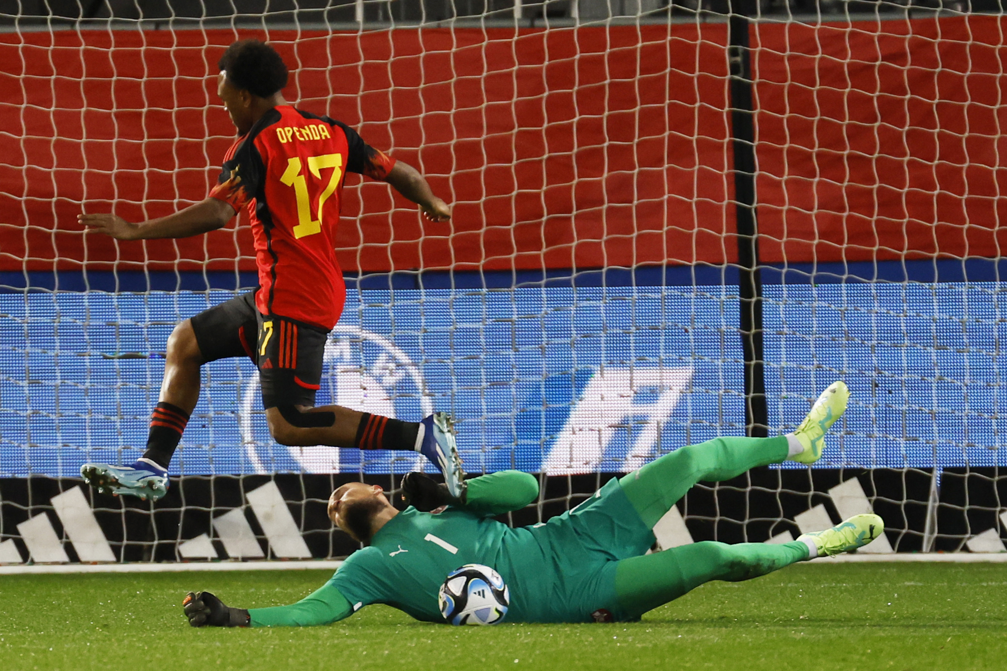 Belgium's Lois Openda, left, takes a shot on goal during the international friendly soccer match between Belgium and Serbia at the Den Dreef stadium in Leuven, Belgium, Wednesday, Nov. 15, 2023. (AP Photo/Geert Vanden Wijngaert)