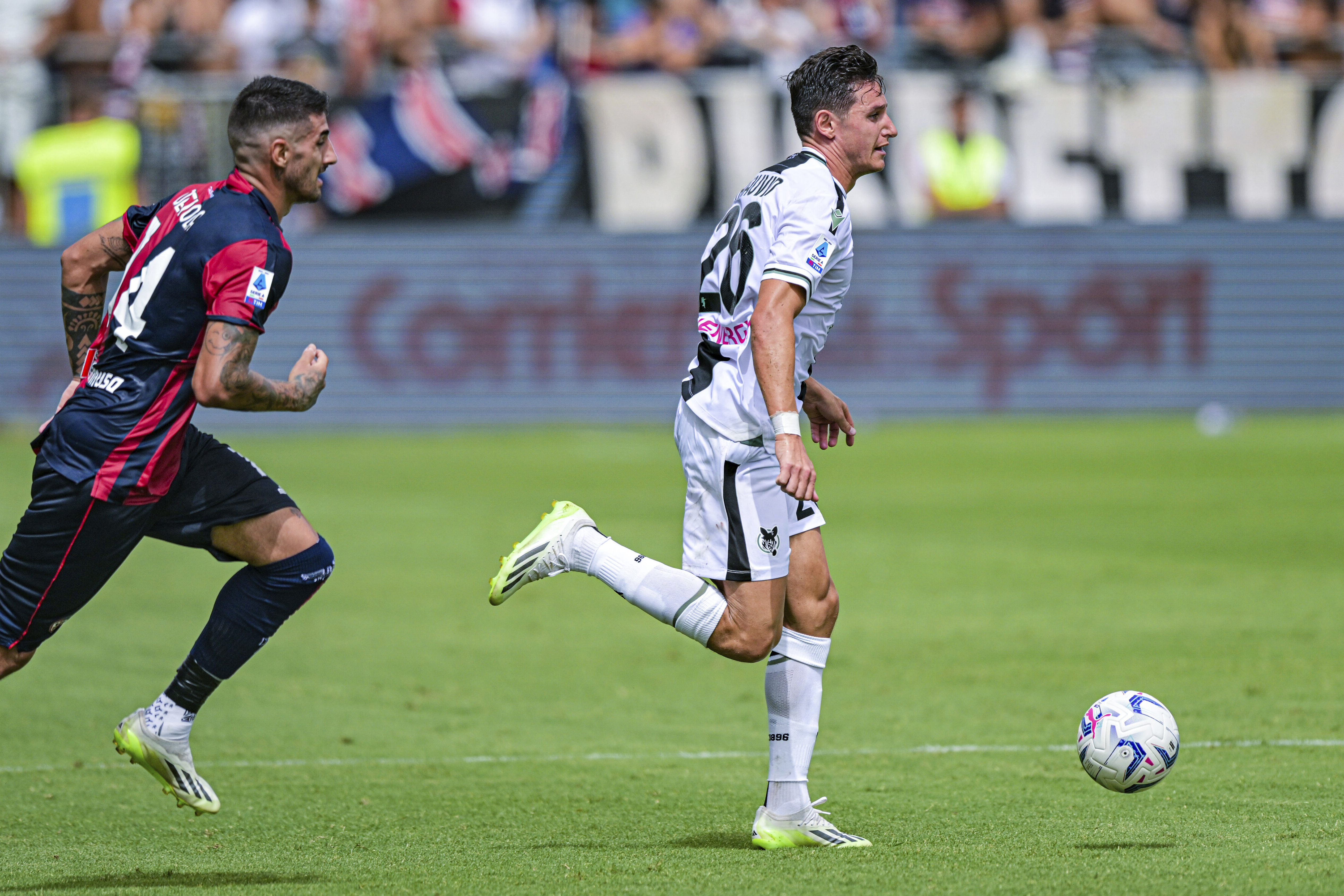 Udinese's Florian Thauvin, right, is chased by Cagliari's Alessandro Deiola during a Serie A soccer league match between Cagliari and Udinese, in Cagliari's Unipol Domus Stadium, Italy, Sunday, Sept. 17, 2023. (Gianluca Zuddas/LaPresse via AP)