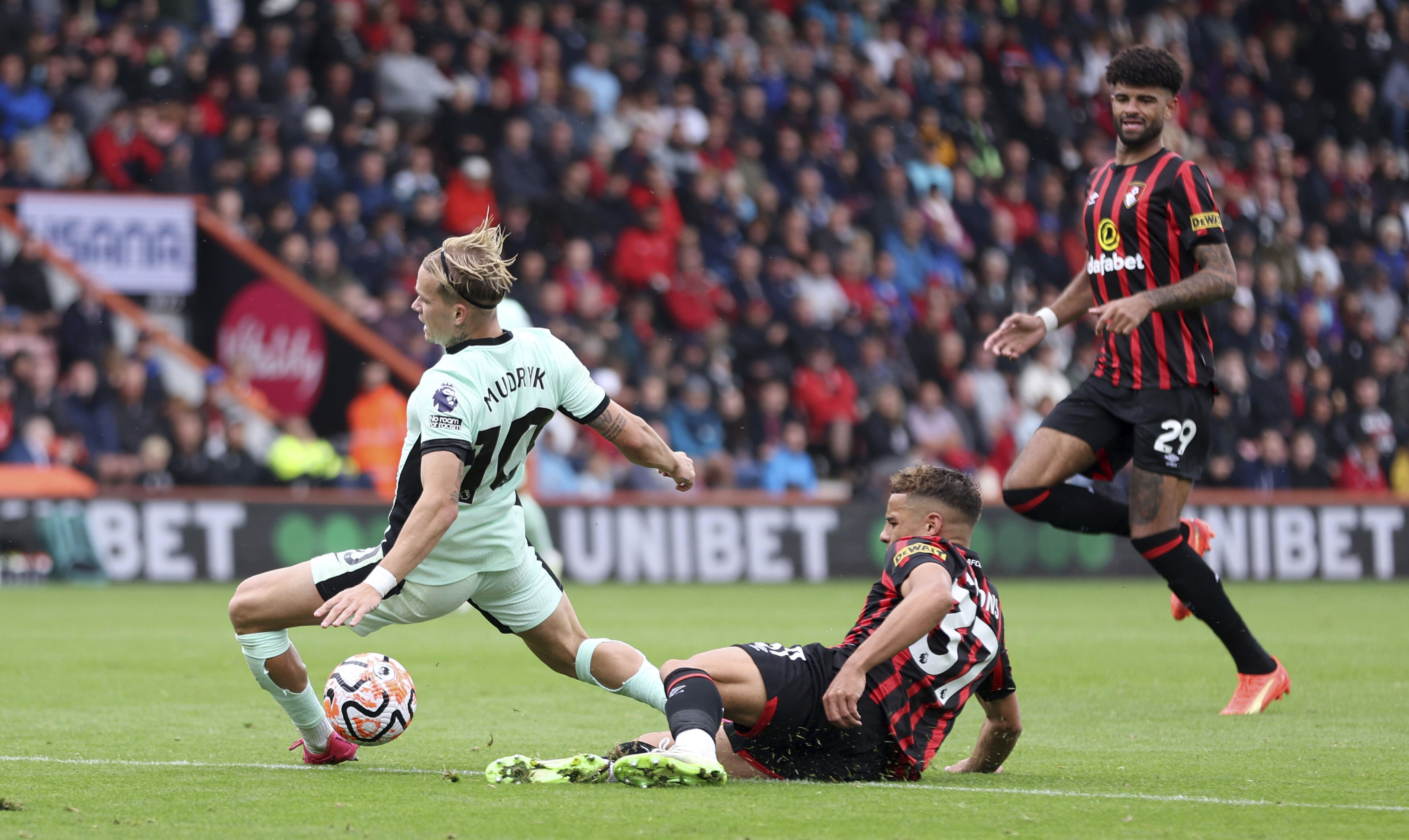 Bournemouth's Max Aarons, right, fouls Chelsea's Mykhaylo Mudryk during the English Premier League soccer match between AFC Bournemouth and Chelsea at Vitality Stadium, Bournemouth, England, Sunday, Sept. 17, 2023. (Steven Paston/PA via AP)