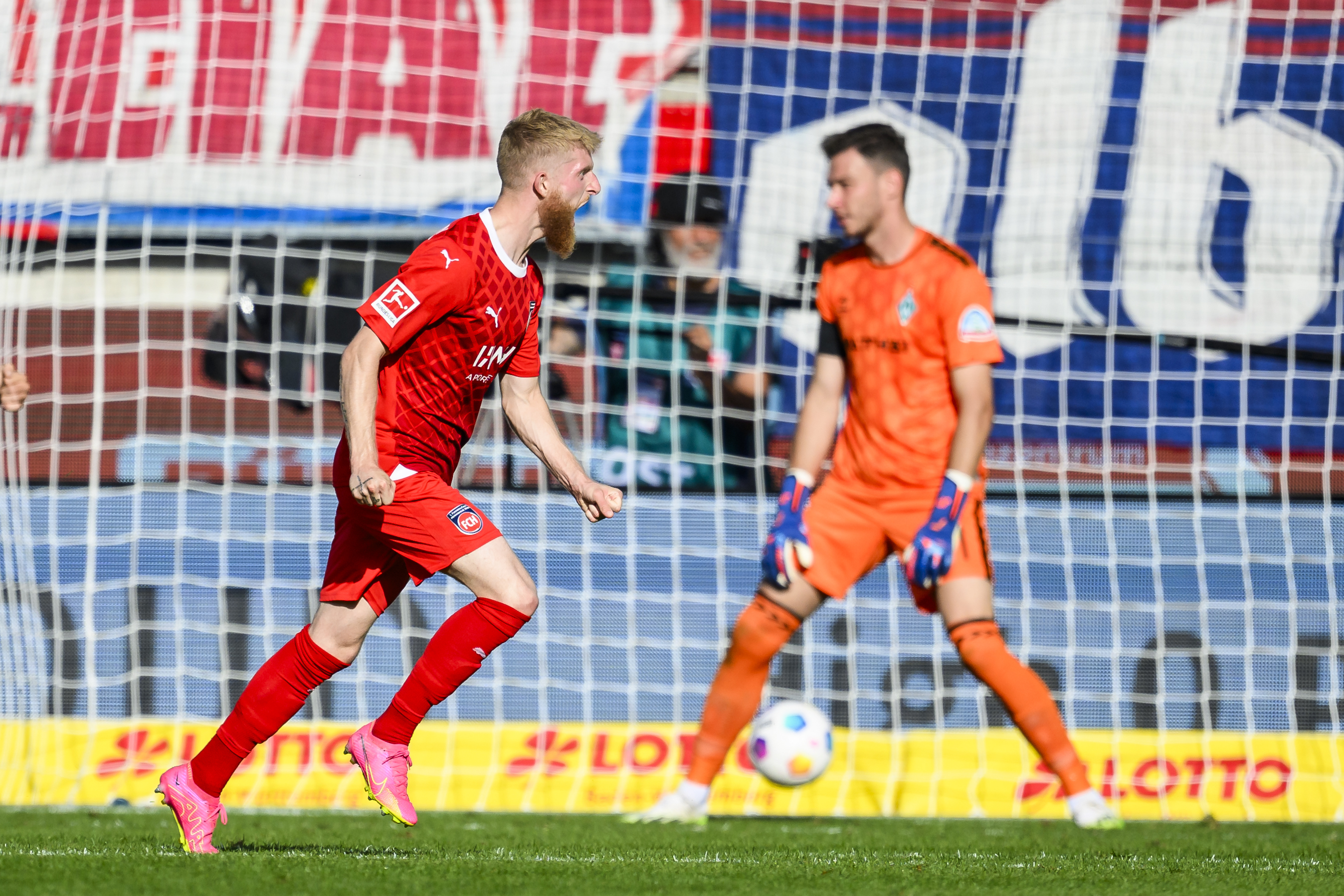 Heidenheim's Jan-Niklas Beste celebrates scoring their side's fourth goal of the game during the German Bundesliga soccer match between 1. FC Heidenheim and Werder Bremen in Heidenheim, Germany, Sunday, Sept. 17, 2023. (Tom Weller/dpa via AP)