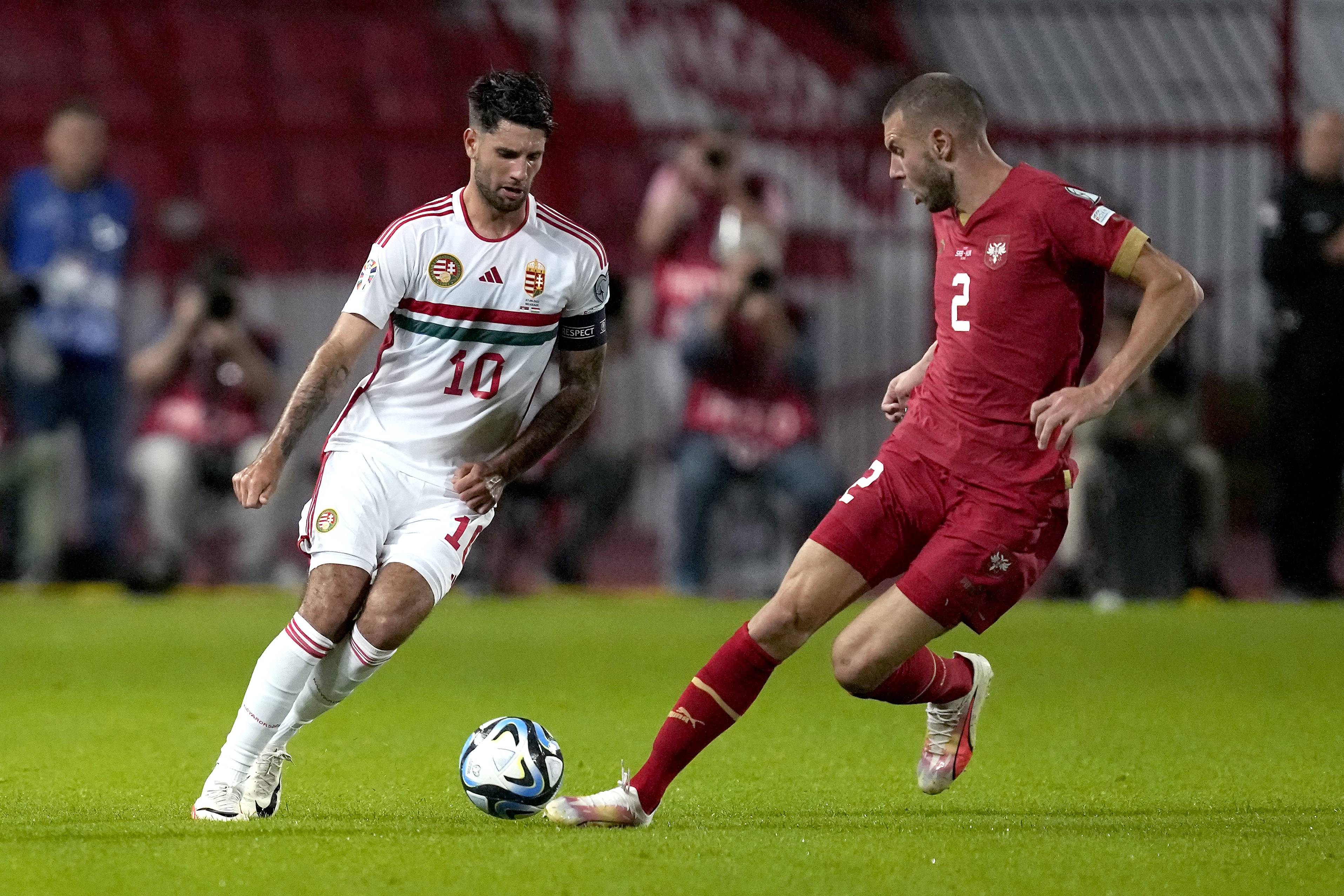 Hungary's Dominik Szoboszlai, left, and Serbia's Strahinja Pavlovic, right, challenge for the ball during the Euro 2024 group G qualifying soccer match between Serbia and Hungary in Belgrade, Serbia, Thursday, Sept. 7, 2023. (AP Photo/Darko Vojinovic)