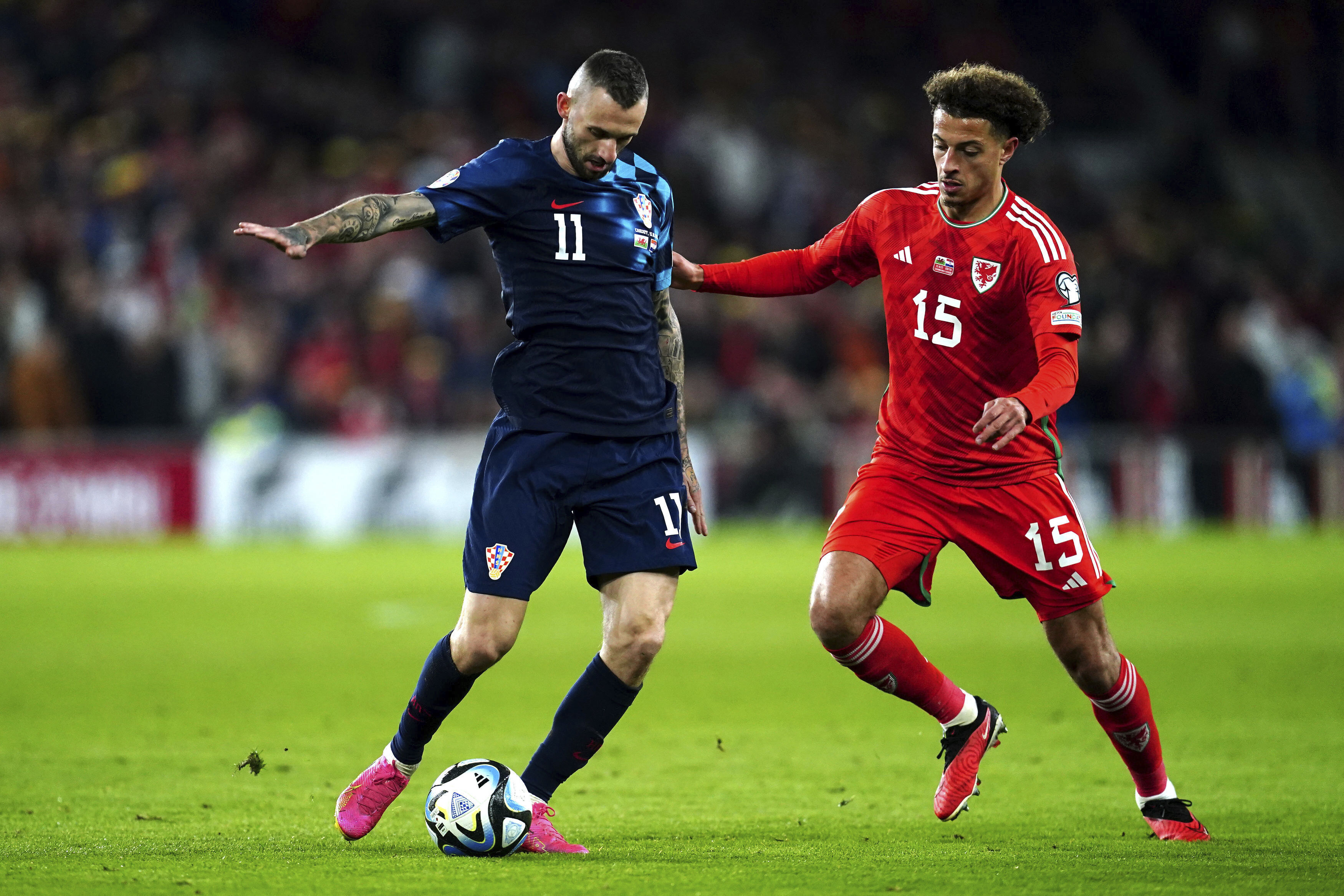 Croatia's Marcelo Brozovic, left and Wales' Ethan Ampadu vie for the ball, during the Euro 2024 Qualifying Group D soccer match between Wales and Croatia,  at the Cardiff City Stadium, in Wales, Sunday, Oct. 15, 2023. (Nick Potts/PA via AP)