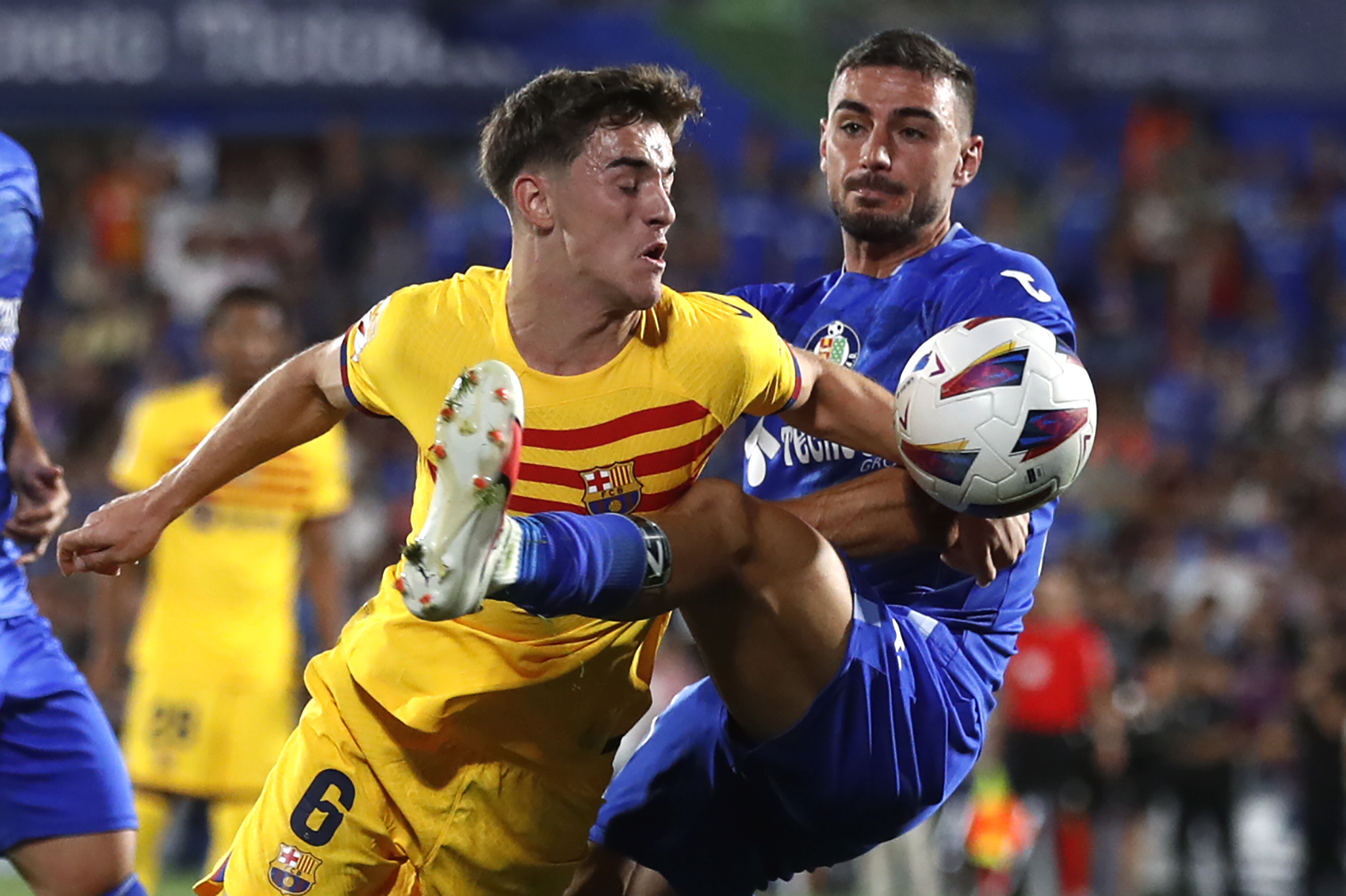 Barcelona's Gavi, left, and Getafe's Juan Iglesias challenge for the ball during the Spanish La Liga soccer match between Getafe and FC Barcelona at the Coliseum Alfonso Perez stadium in Getafe, Spain, Sunday, Aug. 13, 2023. (AP Photo/Alvaro Medranda