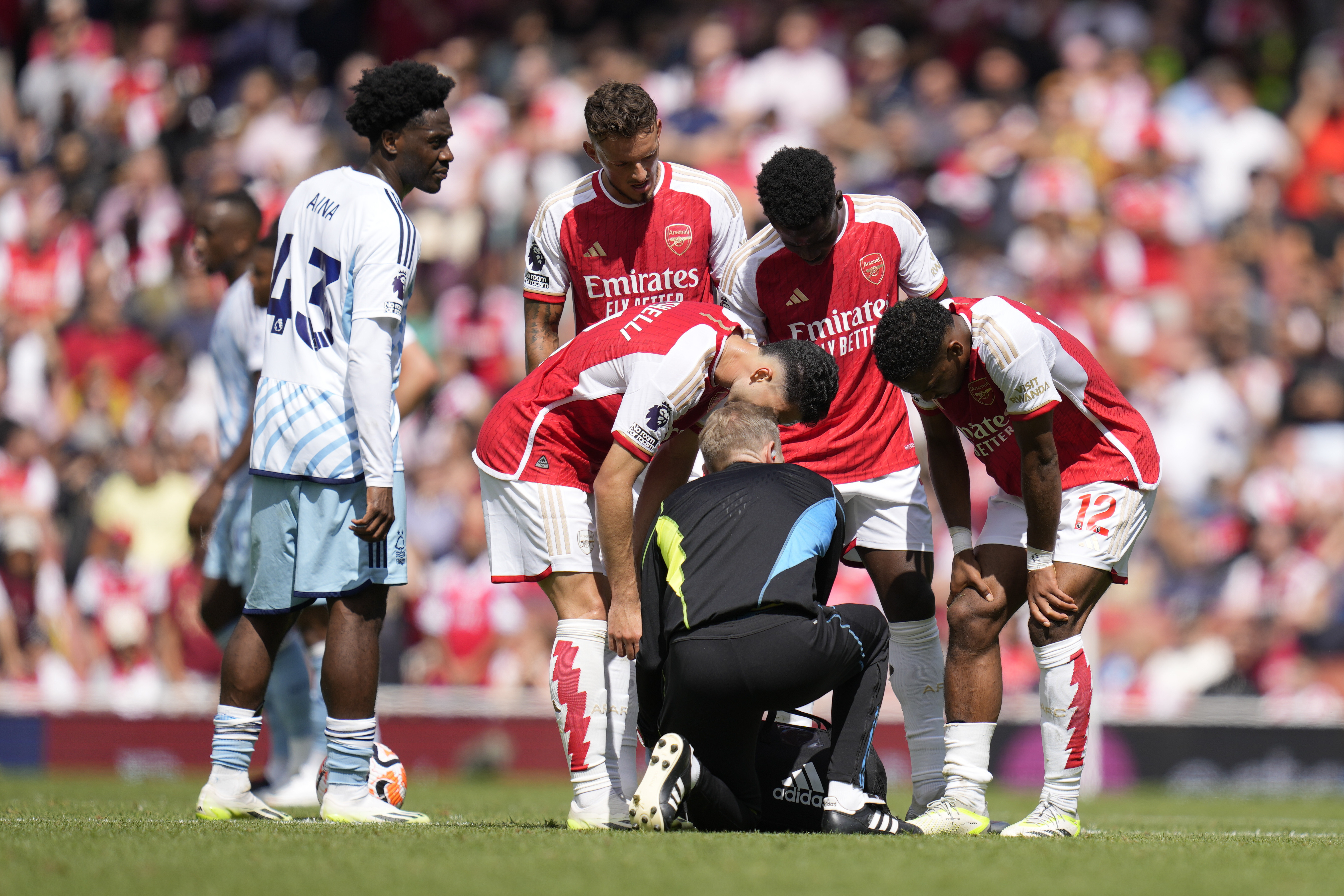 Arsenal's Jurrien Timber, right, talks to a team medical staff member during the English Premier League soccer match between Arsenal and Nottingham Forest at Emirates stadium in London, Saturday, Aug. 12, 2023. (AP Photo/Kirsty Wigglesworth)