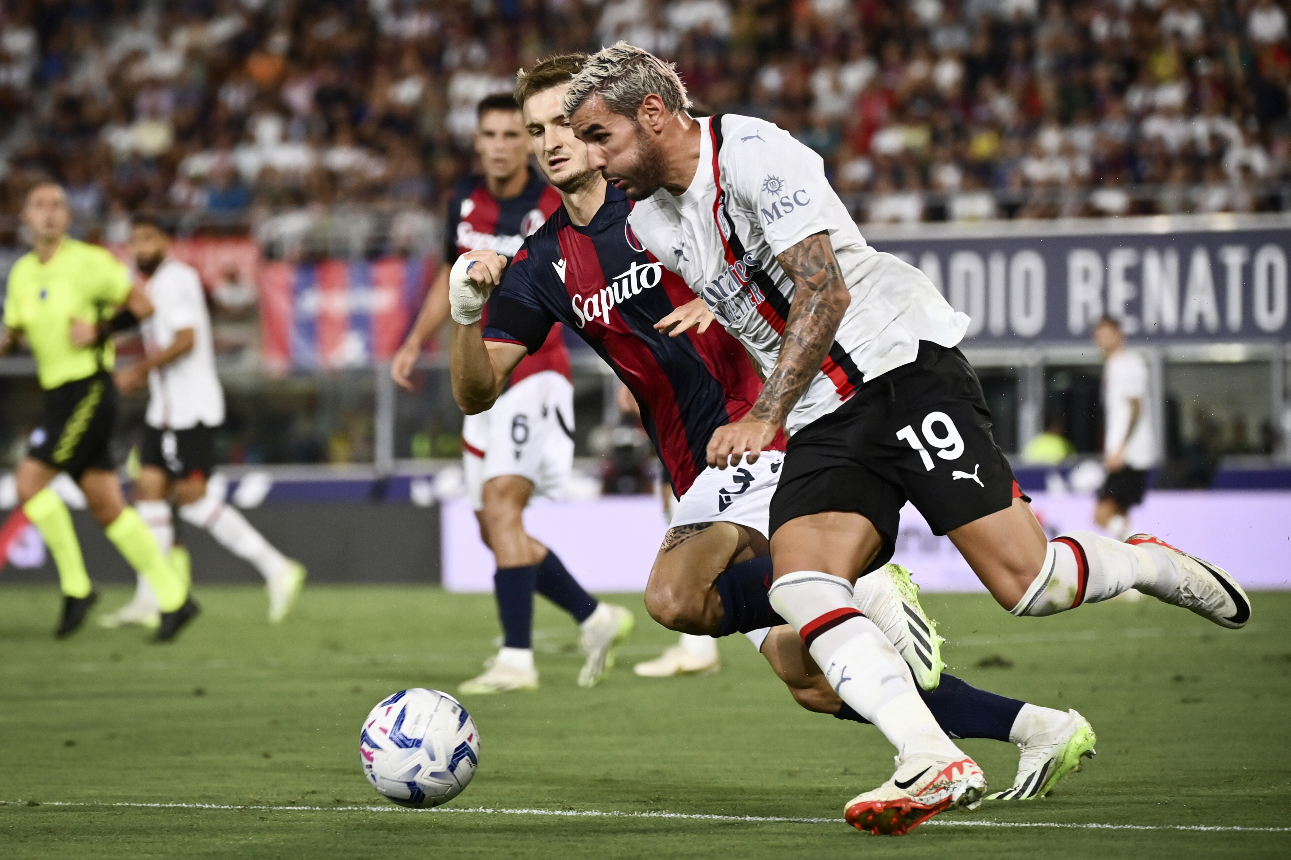 AC Milan's Theo Hernandez, front, and Bologna's Stefan Posch battle for the ball during the Serie A soccer match between Bologna and Milan at Renato Dall'Ara Stadium, Bologna, Italy, Monday Aug. 21, 2023. (Massimo Paolone/LaPresse via AP)