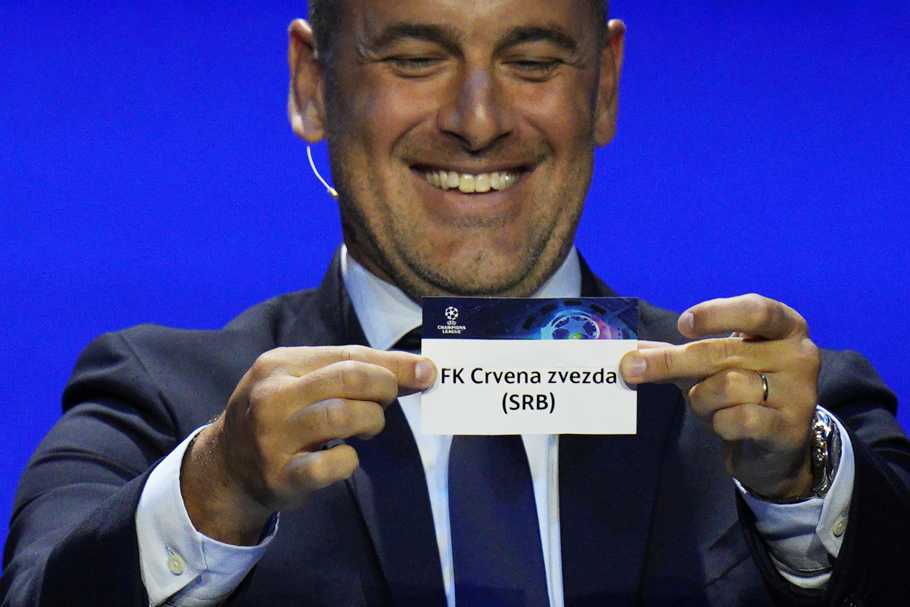 Former soccer star Joe Cole shows a ticket of soccer club FC Crvena zvezda during the 2023/24 UEFA Champions League group stage draw at the Grimaldi Forum in Monaco, Thursday, Aug. 31, 2013. (AP Photo/Daniel Cole)