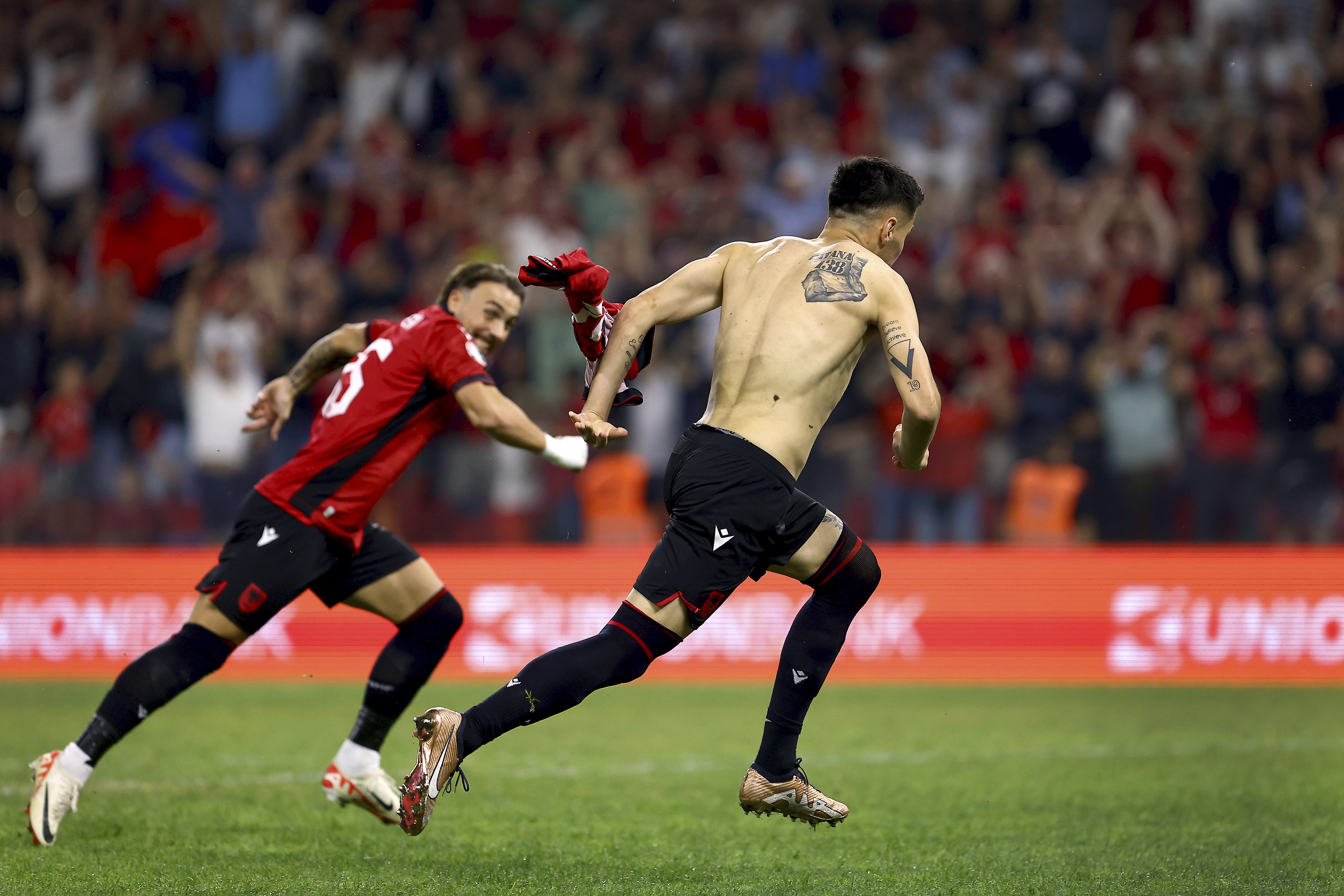 Albania's scorer Mirlind Daku, right, celebrates his side's second goal during the Euro 2024 group E qualifying soccer match between Albania and Poland in Tirana, Albania, Sunday, Sept. 10, 2023. (AP Photo/Franc Zhurda)