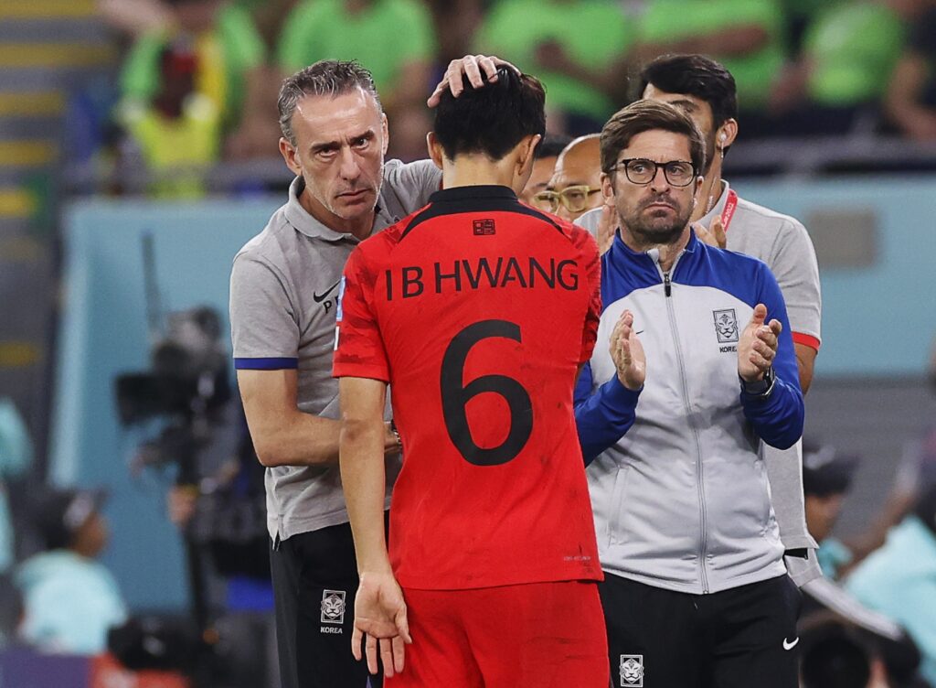epa10350877 South Korea's head coach Paulo Bento (L) comforts Hwang In-beom (C) during the FIFA World Cup 2022 round of 16 soccer match between Brazil and South Korea at Stadium 974 in Doha, Qatar, 05 December 2022.  EPA-EFE/Rungroj Yongrit
