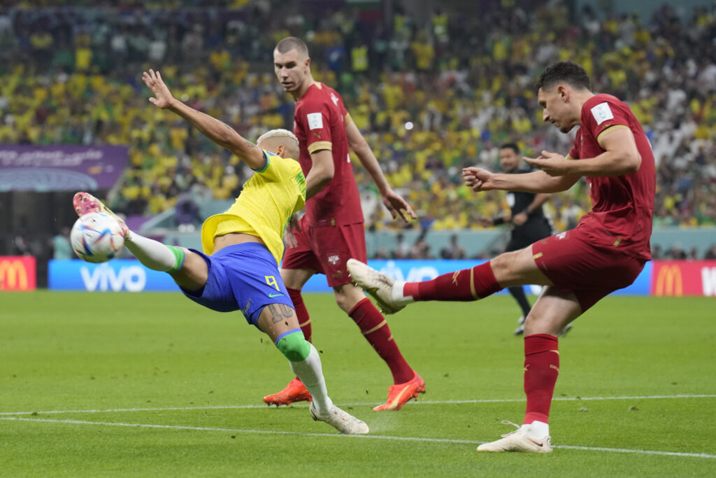 Serbia's Milos Veljkovic, right, kicks the ball ahead of Brazil's Richarlison during the World Cup group G soccer match between Brazil and Serbia, at the Lusail Stadium in Lusail, Qatar, Thursday, Nov. 24, 2022. (AP Photo/Natacha Pisarenko)