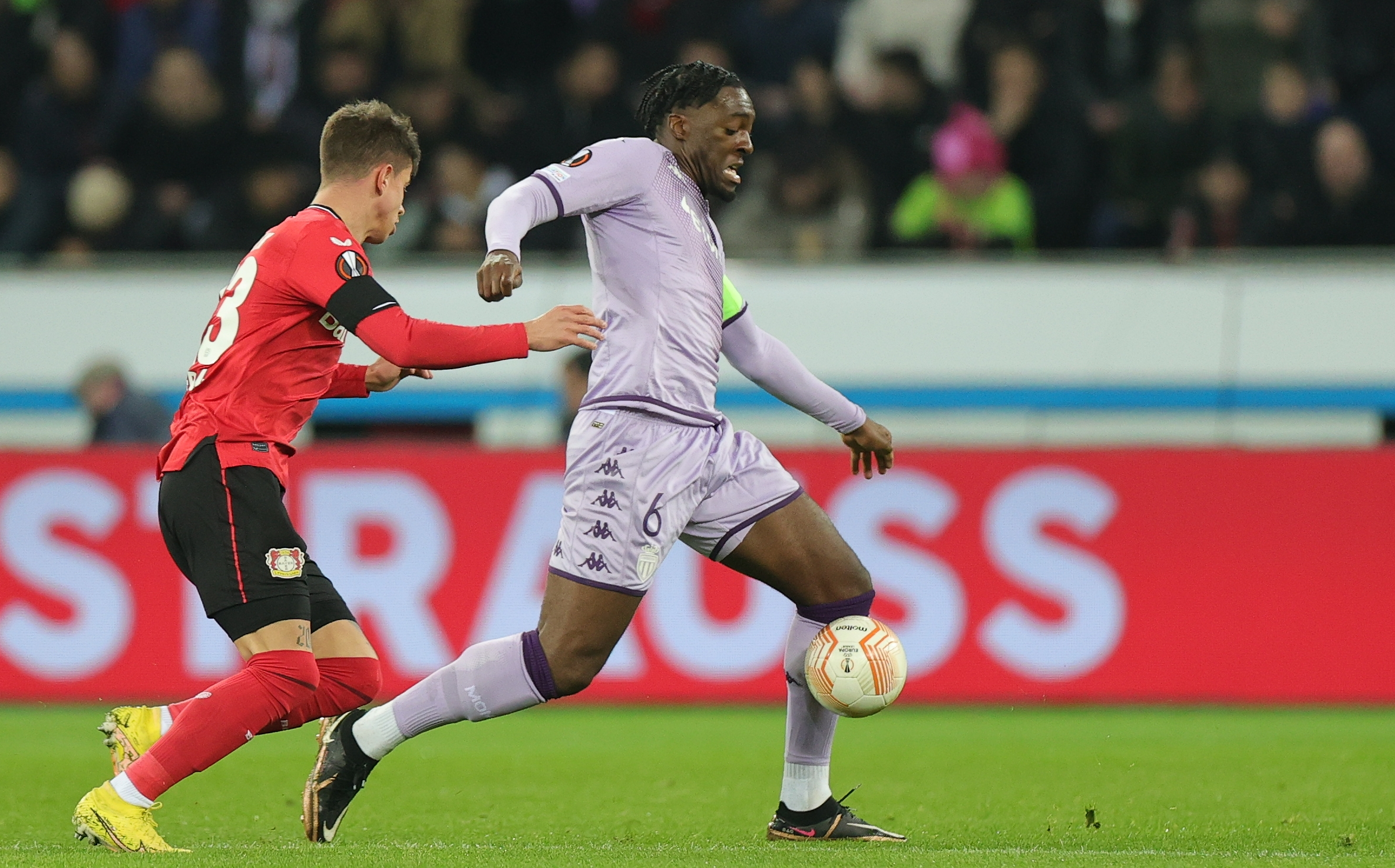 epa10471636 Leverkusen's Adam Hlozek (L) in action against Monaco's Axel Disasi (R) during the UEFA Europa League play-off, 1st leg match between Bayer Leverkusen and AS Monaco in Leverkusen, Germany, 16 February 2023.  EPA-EFE/Friedemann Vogel
