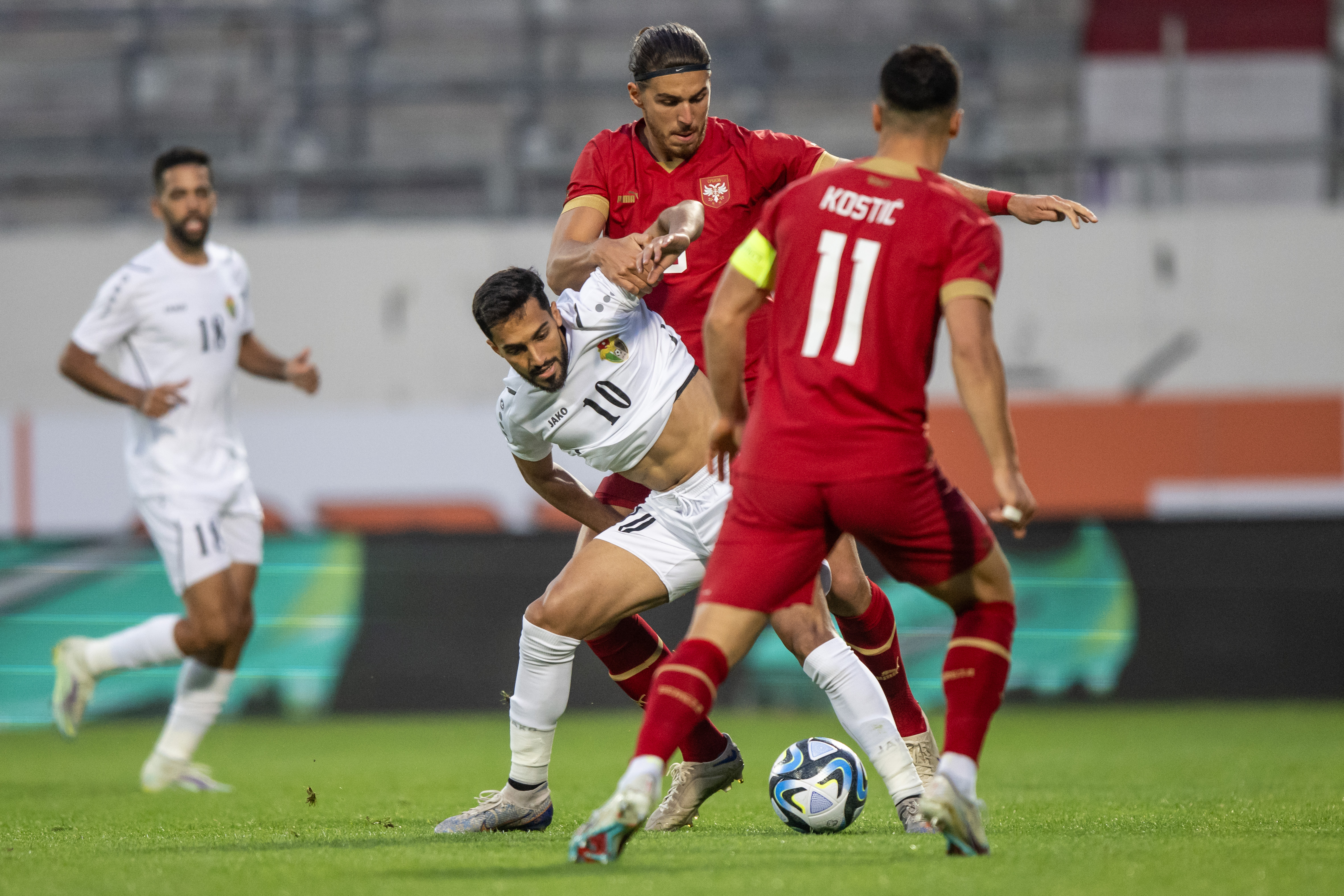 epa10695618 Musa Suleiman of Jordan (L) and Srdjan Babic of Serbia (R) in action during the international friendly soccer match between Serbia and Jordan in Vienna, Austria, 16 June 2023.  EPA-EFE/CHRISTIAN BRUNA