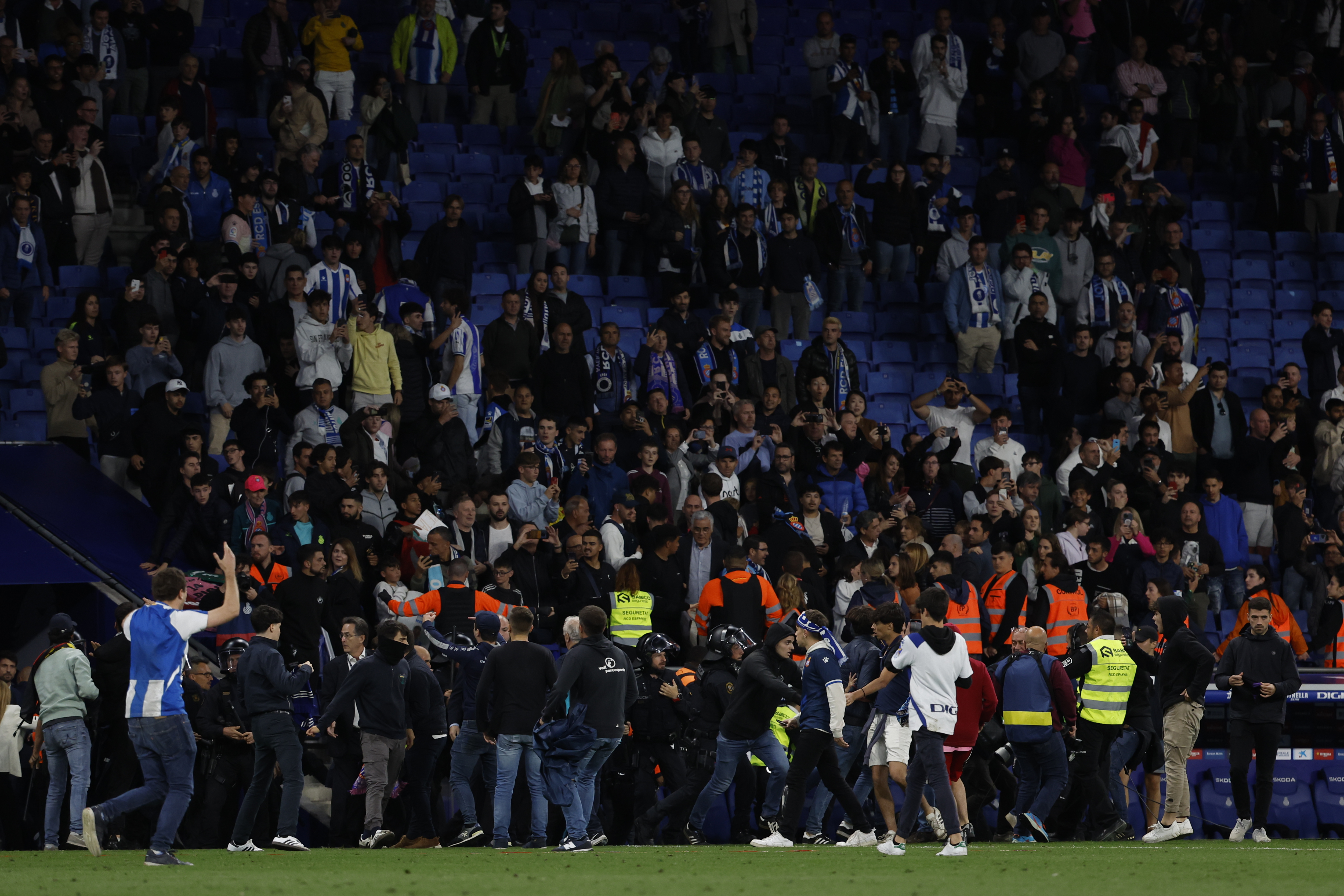 Barcelona supporters run in the file after the Spanish La Liga soccer match between Espanyol and Barcelona at the RCDE stadium in Barcelona, Sunday, May 14, 2023. (AP Photo/Joan Monfort)