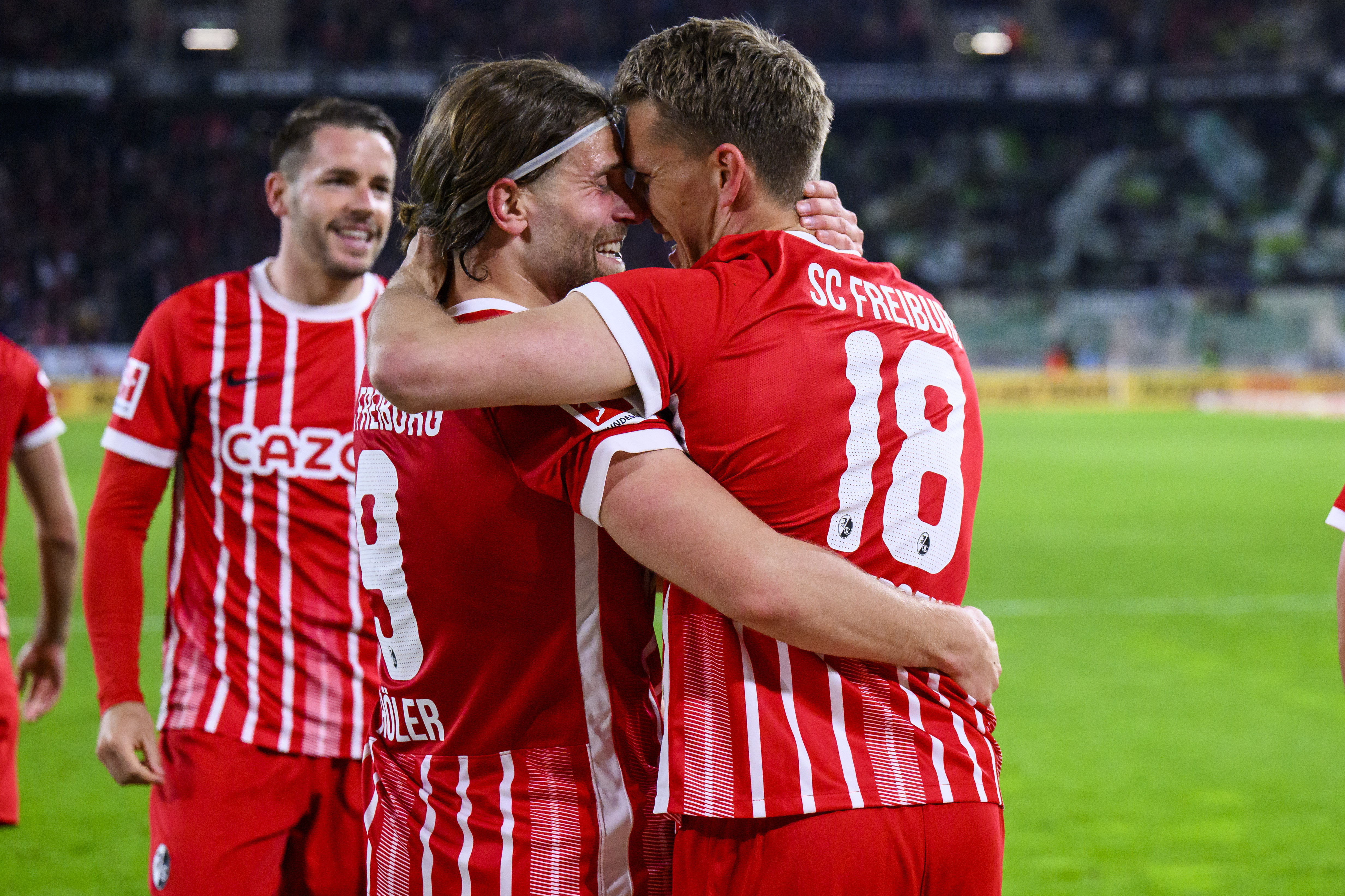 Freiburg's Nils Petersen, right, celebrates scoring with Lucas Holer during the Bundesliga soccer match between SC Freiburg and VfL Wolfsburg at Europa-Park Stadion, Freiburg, Germany, Friday May 19, 2023. (Tom Weller/dpa via AP)