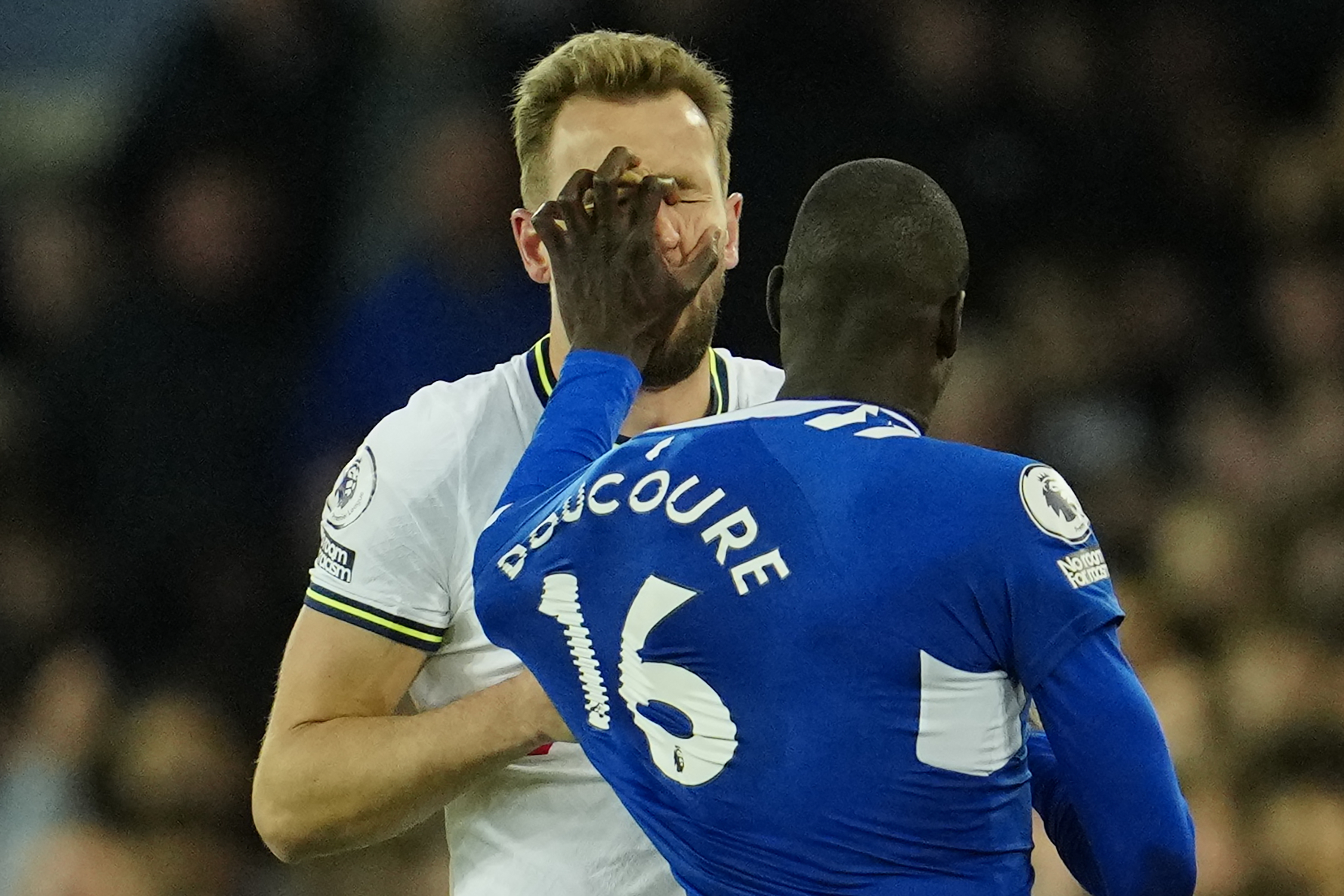 Tottenham's Harry Kane is pushed by Everton's Abdoulaye Doucoure during the English Premier League soccer match between Everton and Tottenham Hotspur at the Goodison Park stadium in Liverpool, England, Monday, April 3, 2023. (AP Photo/Jon Super)