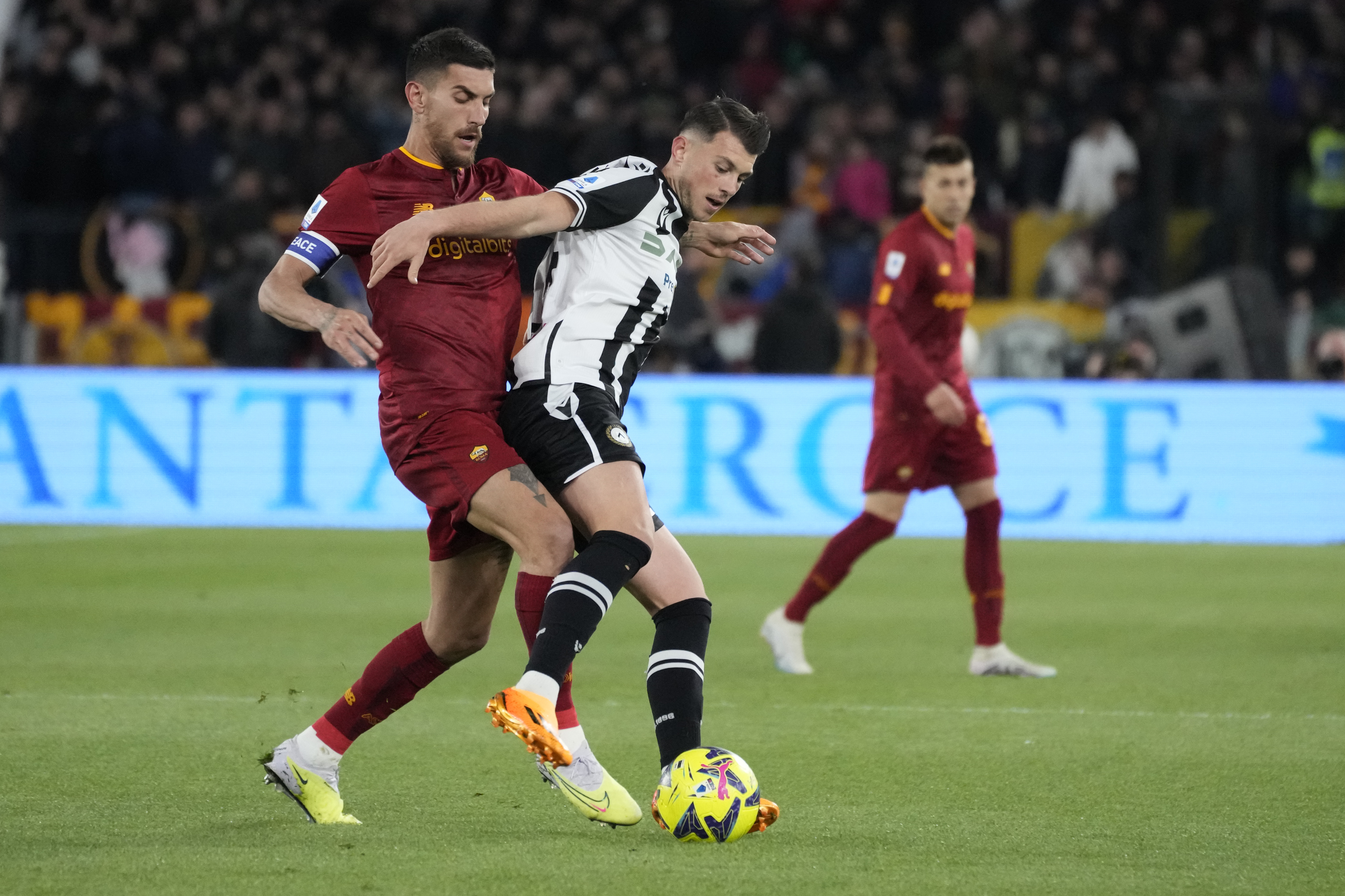 Roma's Lorenzo Pellegrini, left, and Udinese's Lazar Samardzic challenge for the ball during the Serie A soccer match between Roma and Udinese at Rome's Olympic Stadium, Sunday, April 16, 2023. (AP Photo/Andrew Medichini)