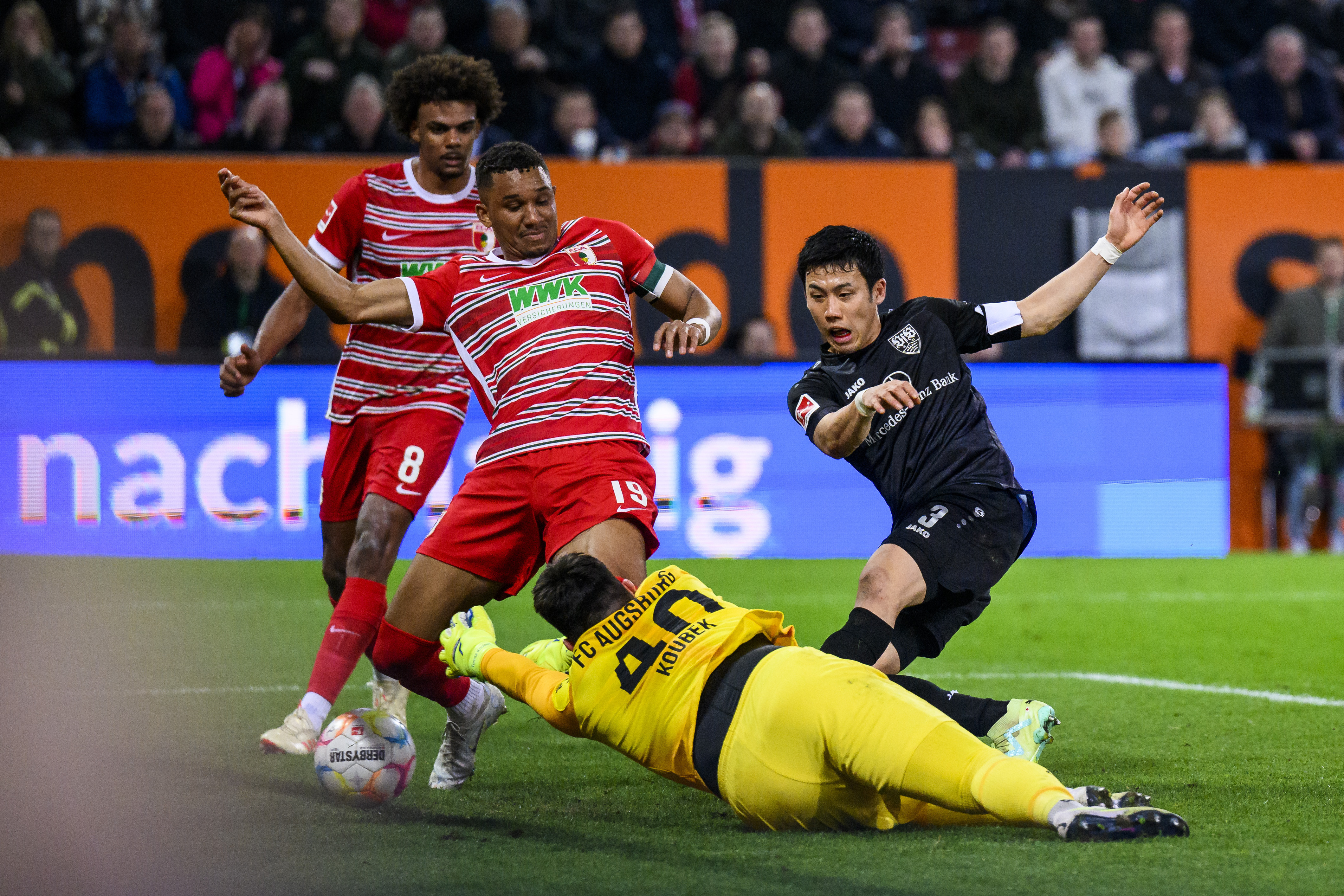 Stuttgart's Wataru Endo, right, scores to 1-1 during the Bundesliga soccer match between FC Augsburg and VfB Stuttgart at the WWK Arena in Augsburg, Germany, Friday April 21, 2023. (Tom Weller/dpa via AP)