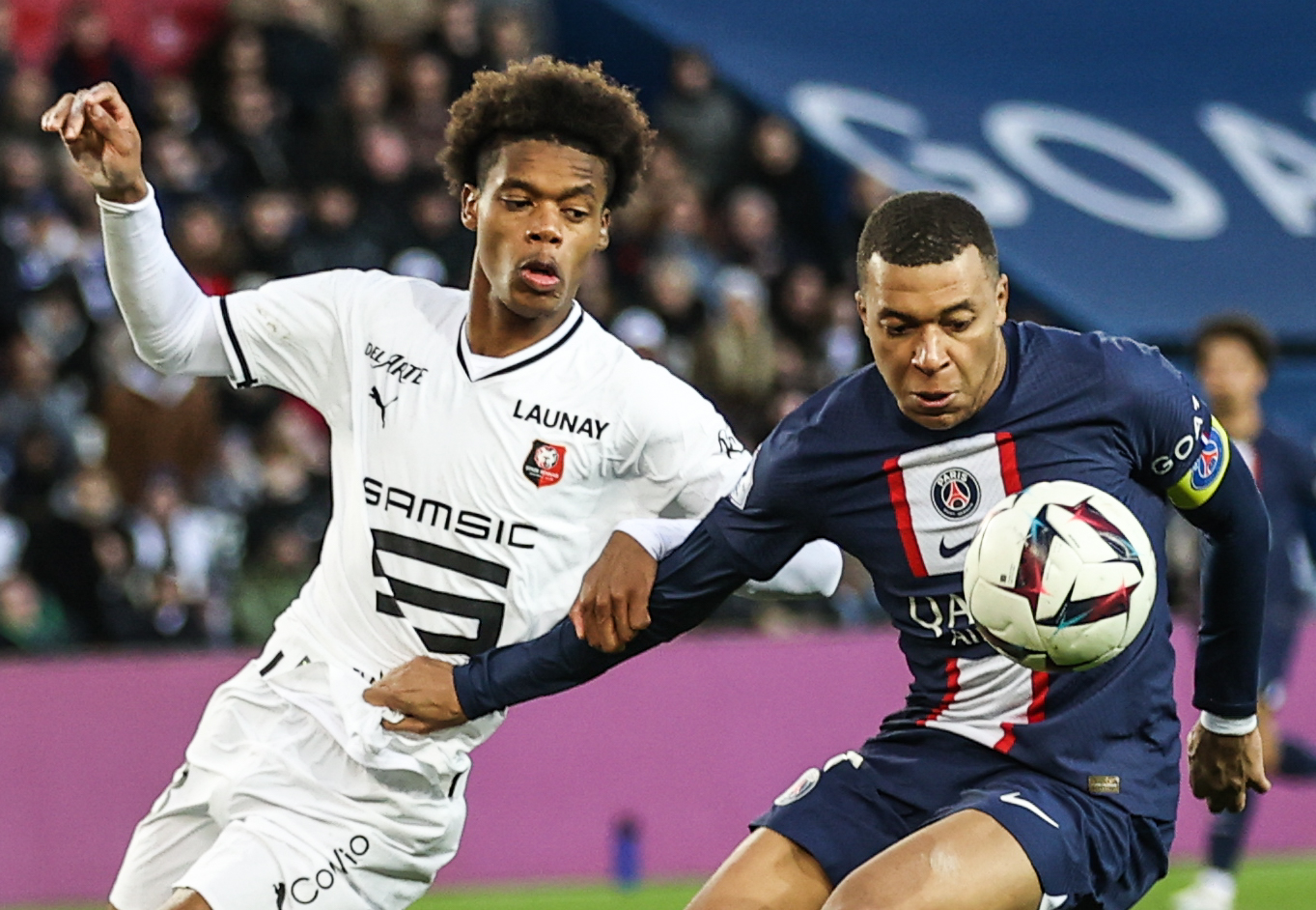 epa10532667 Paris Saint Germain's Kylian Mbappe (R) and Warmed Omari of Rennes  in action during the French Ligue 1 soccer match between Paris Saint Germain and Stades Rennais FC in Paris, France, 19 March 2023.  EPA-EFE/MOHAMMED BADRA