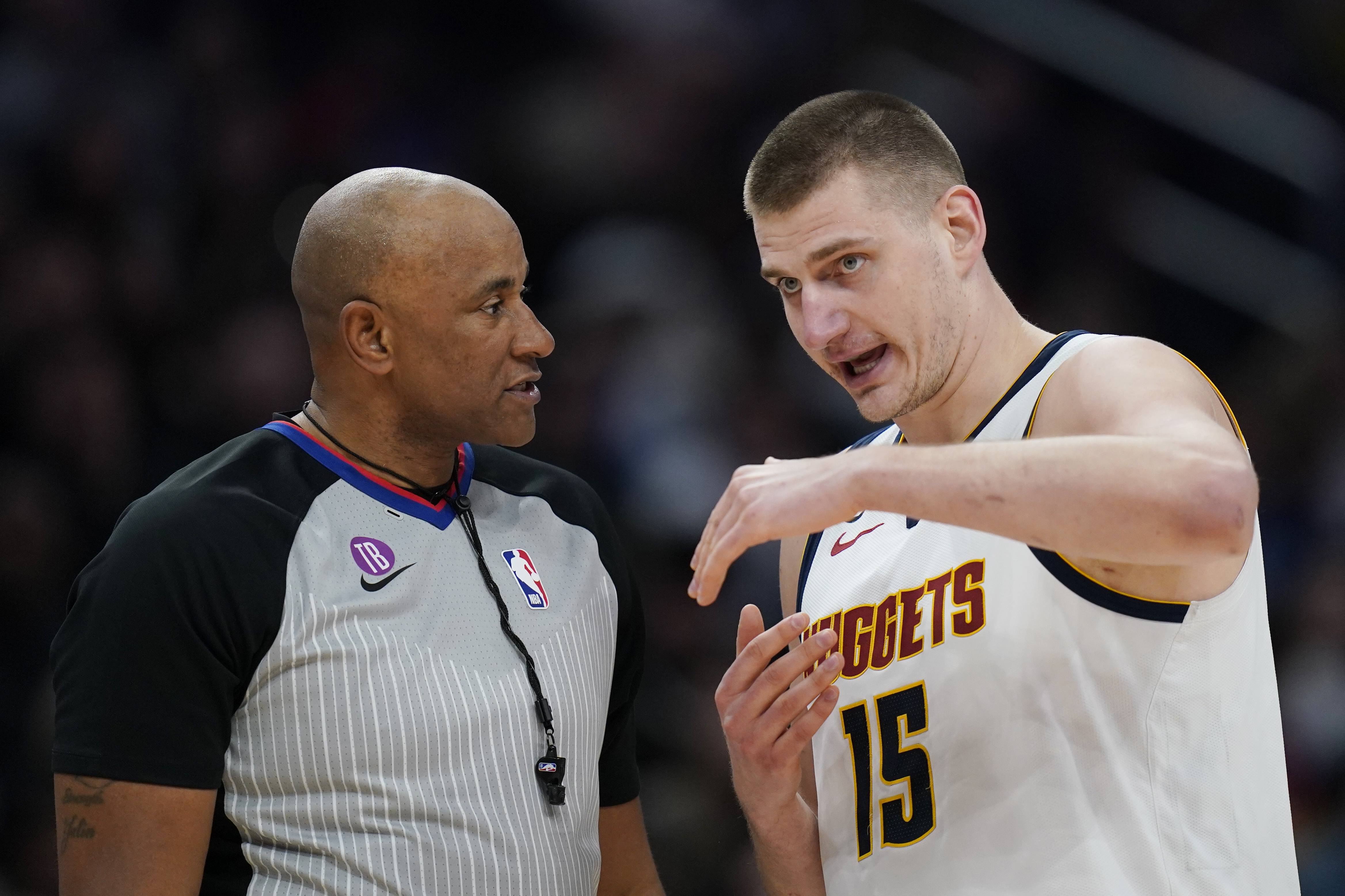 Denver Nuggets center Nikola Jokic (15) reacts to a call to referee Kevin Cutler (34) during the first half of an NBA basketball game Wednesday, March 22, 2023, in Washington. The Nuggets won 118-104. (AP Photo/Carolyn Kaster)