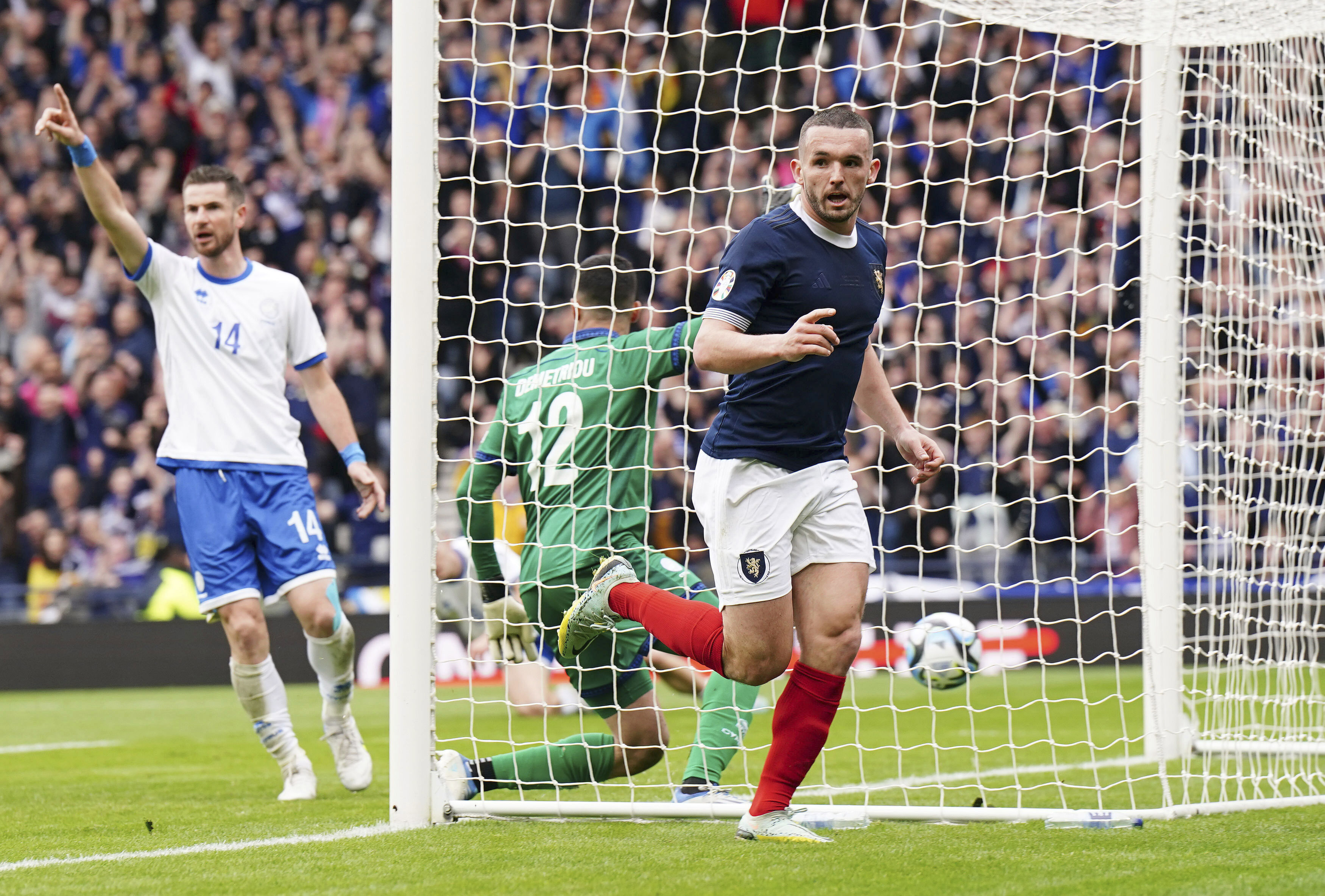 Scotland's John McGinn celebrates scoring his side's first goal of the game, during the Euro 2024 Group A qualifying soccer match between Scotland and Cyprus at Hampden Park, in Glasgow, Scotland, Saturday March 25, 2023. (Jane Barlow/PA via AP)