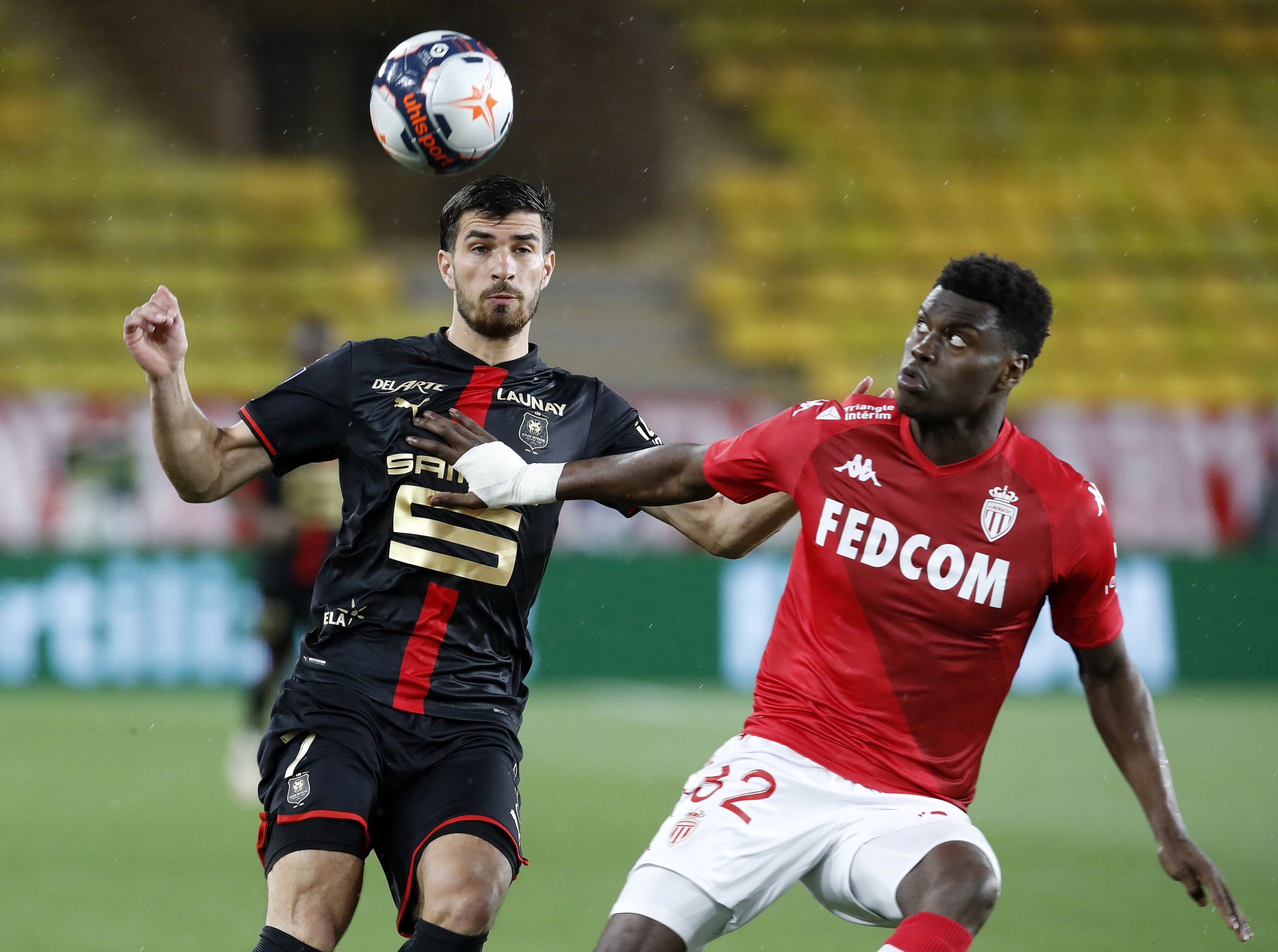 epa09205431 Benoit Badiashile (R) of AS Monaco and Martin Terrier (L) of Rennes in action during the French Ligue 1 soccer match, AS Monaco vs Stade Rennais FC, at Stade Louis II, in Monaco, 16 May 2021.  EPA-EFE/SEBASTIEN NOGIER