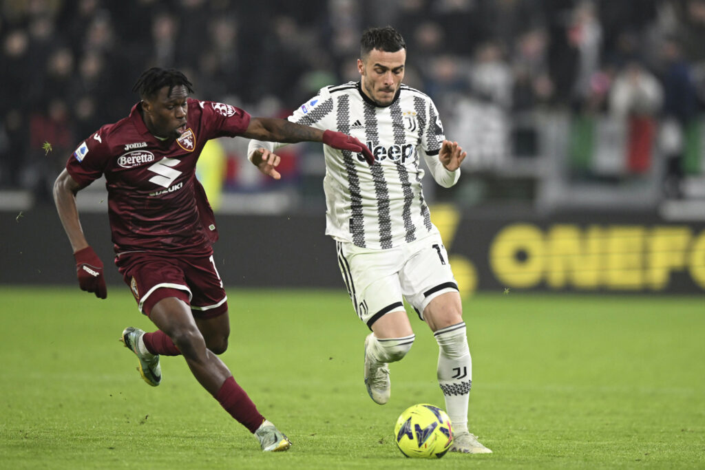 Juventus' Filip Kostic, right, and Torino's Wilfried Singo in action during the Serie A soccer match between Juventus and Torino at Juventus Stadium, Turin, Italy, Tuesday Feb. 28, 2023. (Tano Pecoraro/LaPresse via AP)