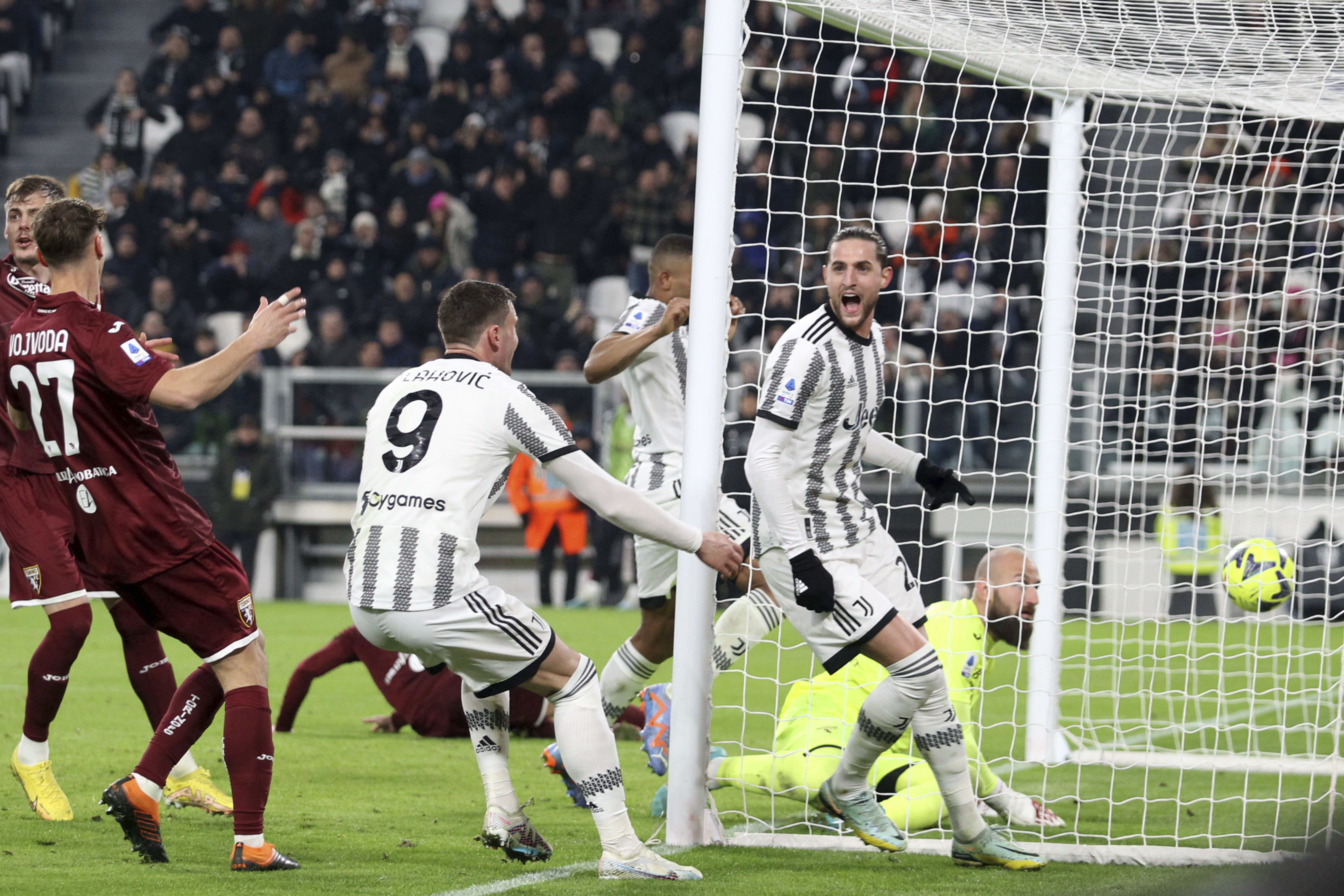 Juventus' Adrien Rabiot, right, celebrates scoring during the Serie A soccer match between Juventus and Torino at Juventus Stadium, Turin, Italy, Tuesday Feb. 28, 2023. (Tano Pecoraro/LaPresse via AP)