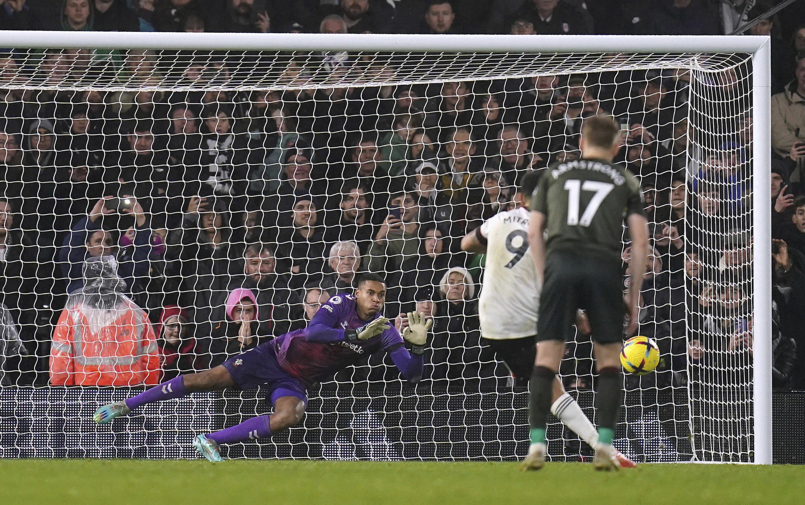 Fulham's Aleksandar Mitrovic sees his penalty saved by Southampton goalkeeper Gavin Bazunu during the Premier League match between Fulham and Southampton' at Craven Cottage, London, Saturday Dec. 31, 2022. (John Walton/PA via AP)