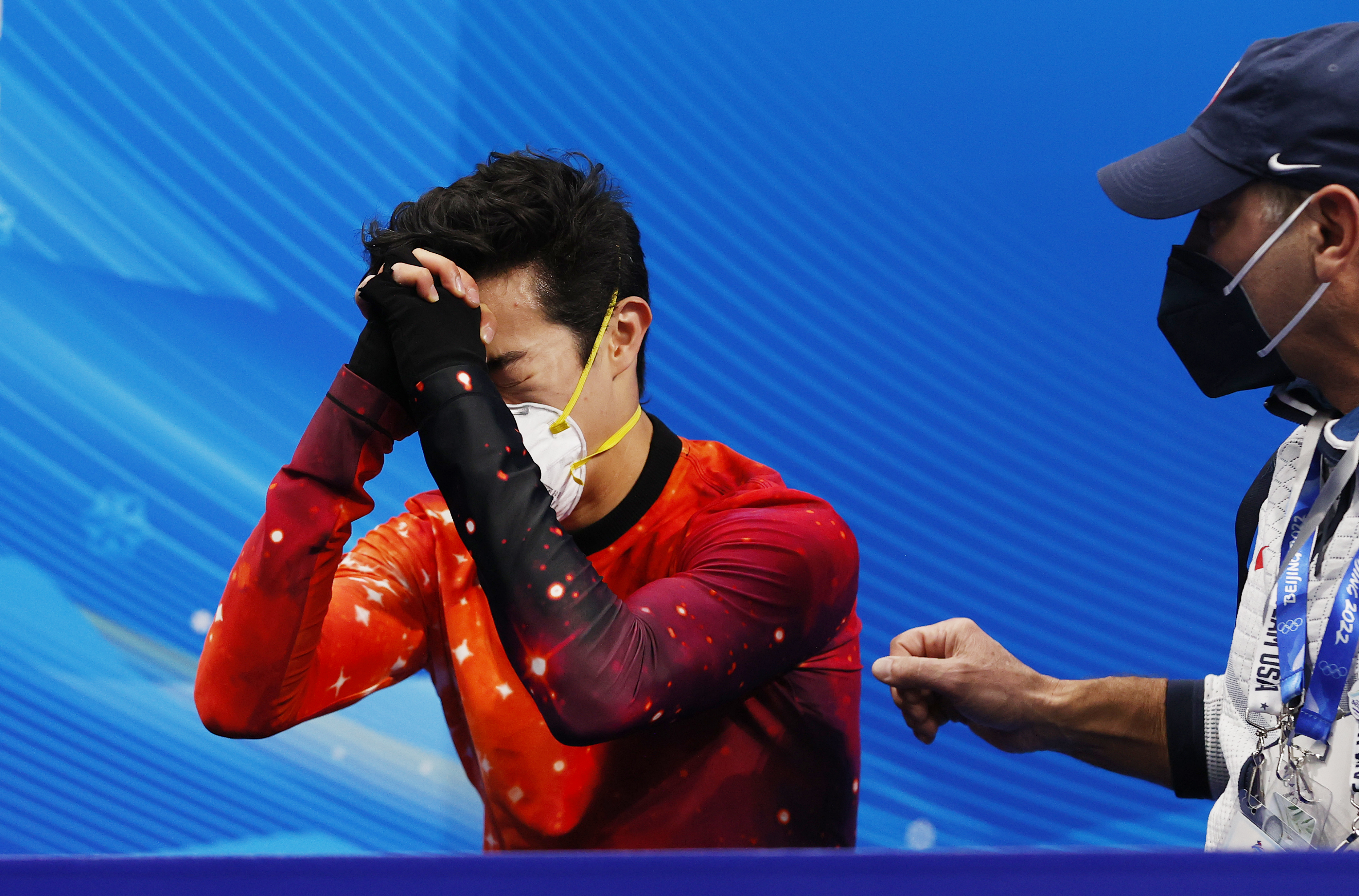 epa09742819 Nathan Chen (L) of USA and his coach Rafael Arutunian celebrate after Chen won the Men's Free Skating of the Figure Skating events at the Beijing 2022 Olympic Games, Beijing, China, 10 February 2022.  EPA-EFE/HOW HWEE YOUNG