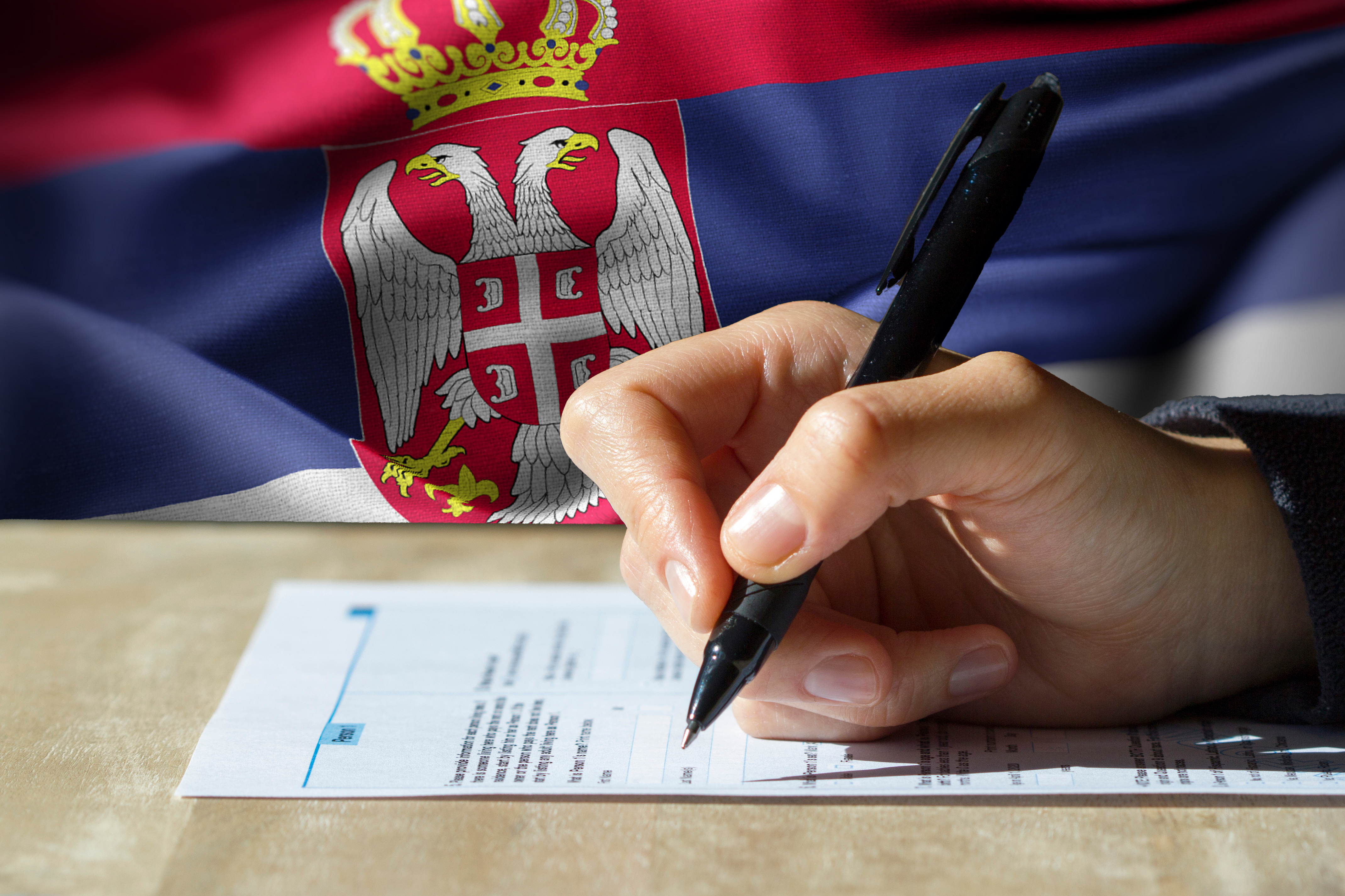 Closeup,Of,Woman's,Hand,Holding,A,Pen,Filling,Out,A