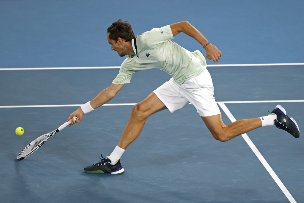 Daniil Medvedev of Russia plays a forehand return to Stefanos Tsitsipas of Greece during their semifinal match at the Australian Open tennis championships in Melbourne, Australia, Friday, Jan. 28, 2022. (AP Photo/Tertius Pickard)