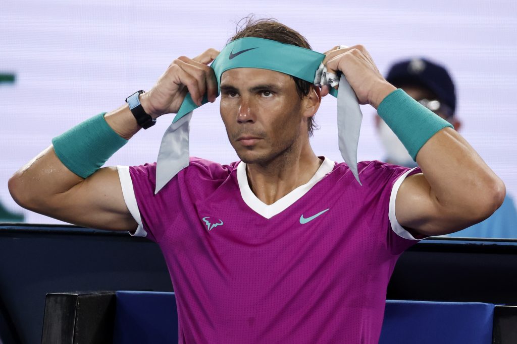 Rafael Nadal of Spain changes his headband during a break in his semifinal against Matteo Berrettini of Italy at the Australian Open tennis championships in Melbourne, Australia, Friday, Jan. 28, 2022. (AP Photo/Hamish Blair)