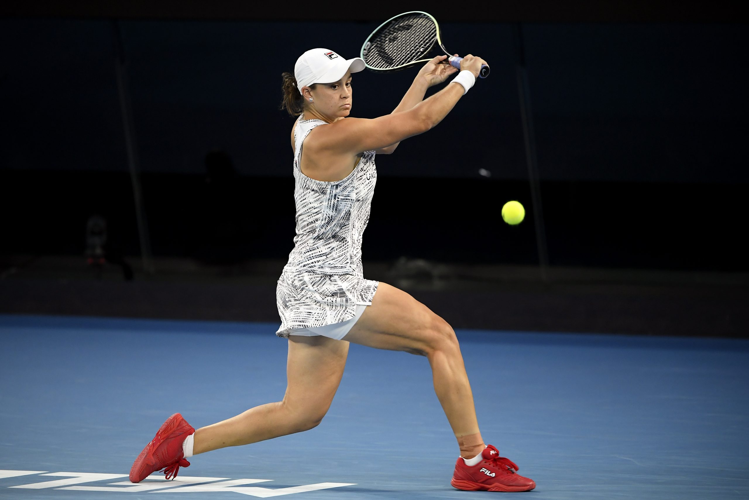 Ash Barty of Australia plays a backhand return to Danielle Collins of the U.S. during the women's singles final at the Australian Open tennis championships in Saturday, Jan. 29, 2022, in Melbourne, Australia. (AP Photo/Andy Brownbill)