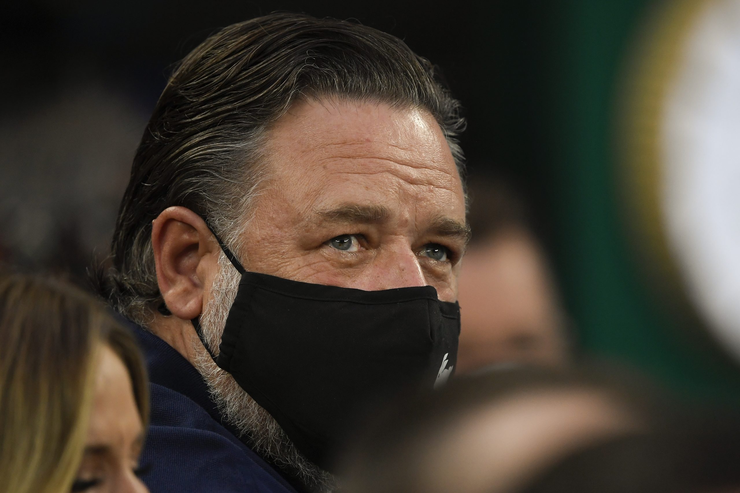 New Zealand actor Russell Crowe watches the women's singles final between Ash Barty of Australia and Danielle Collins of the U.S., at the Australian Open tennis championships in Saturday, Jan. 29, 2022, in Melbourne, Australia. (AP Photo/Andy Brownbill)