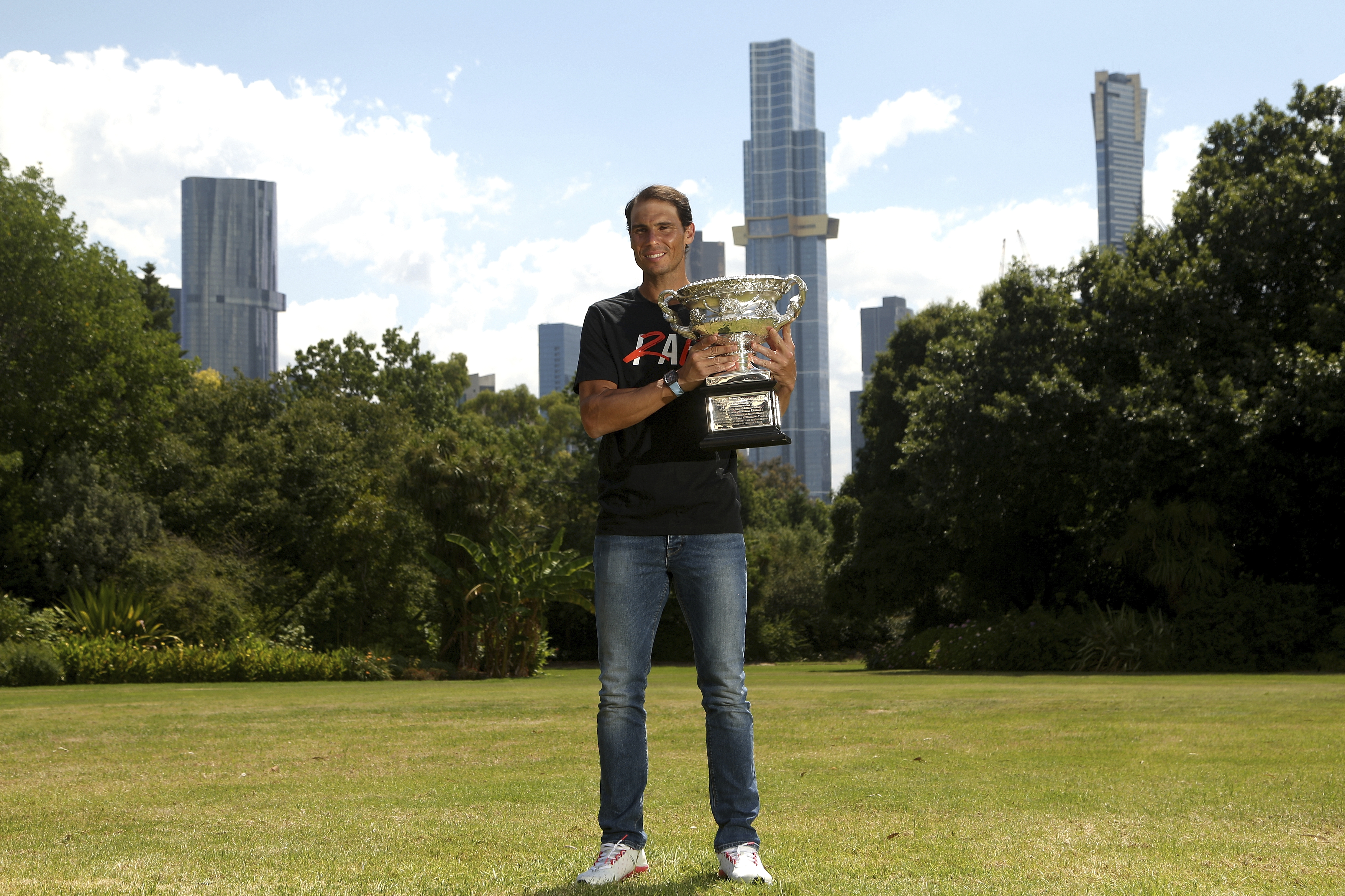 Men's singles champion Rafael Nadal of Spain poses for a photo with his trophy at Government House after the Australian Open in Melbourne, Australia, Monday, Jan. 31, 2022. (AP Photo/Hamish Blair)