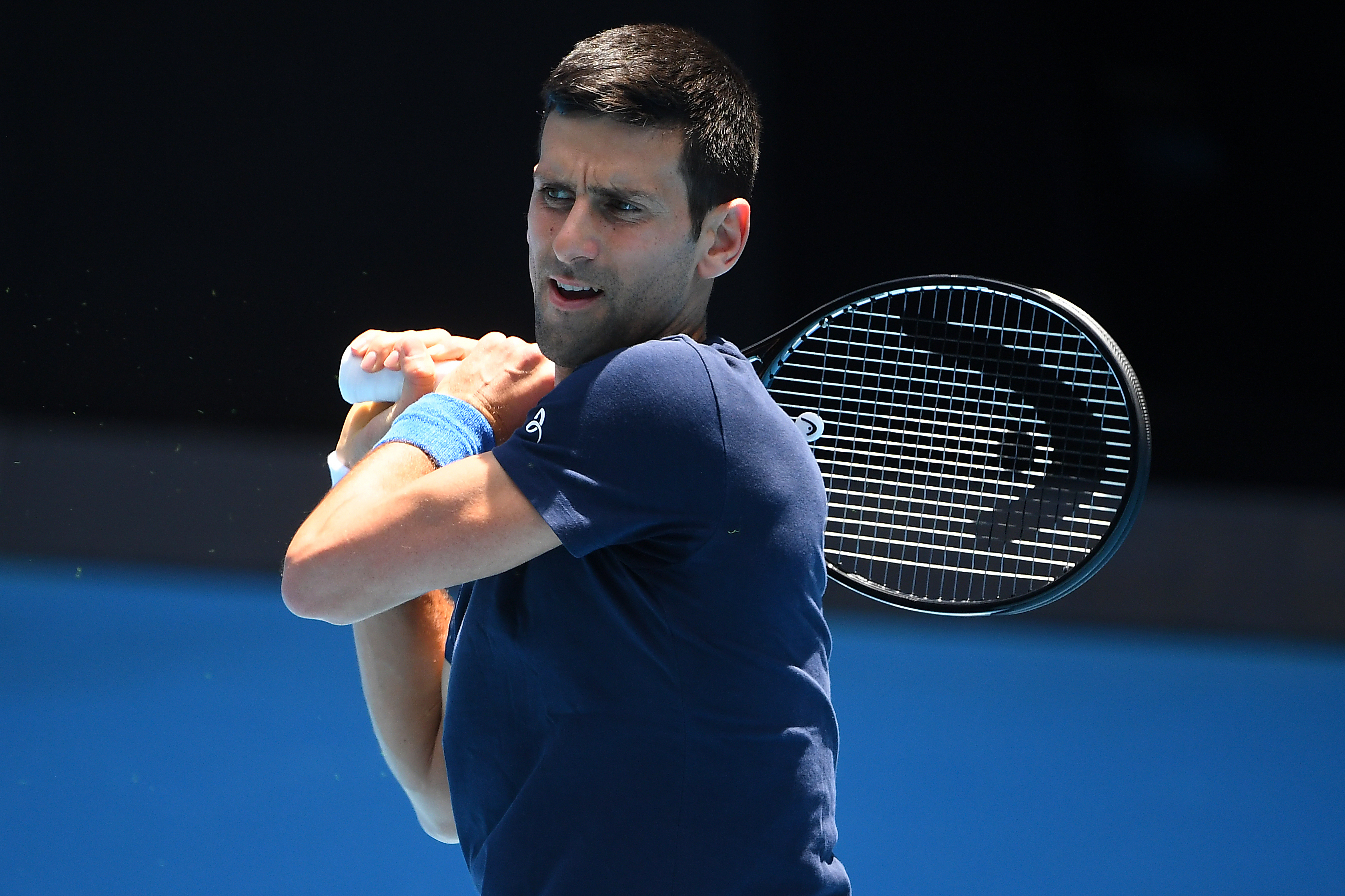 epa09679689 Novak Djokovic of Serbia is seen in action  during a training session at Melbourne Park in Melbourne, Australia, 12 January 2022.  EPA-EFE/JAMES ROSS  AUSTRALIA AND NEW ZEALAND OUT