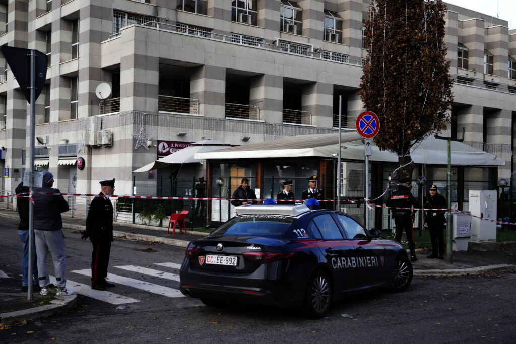 Italian Carabinieri, paramilitary policemen, patrol in front of a bar where three people died after a man entered and shot in Rome, Sunday, Dec. 11, 2022. (AP Photo/Gregorio Borgia)