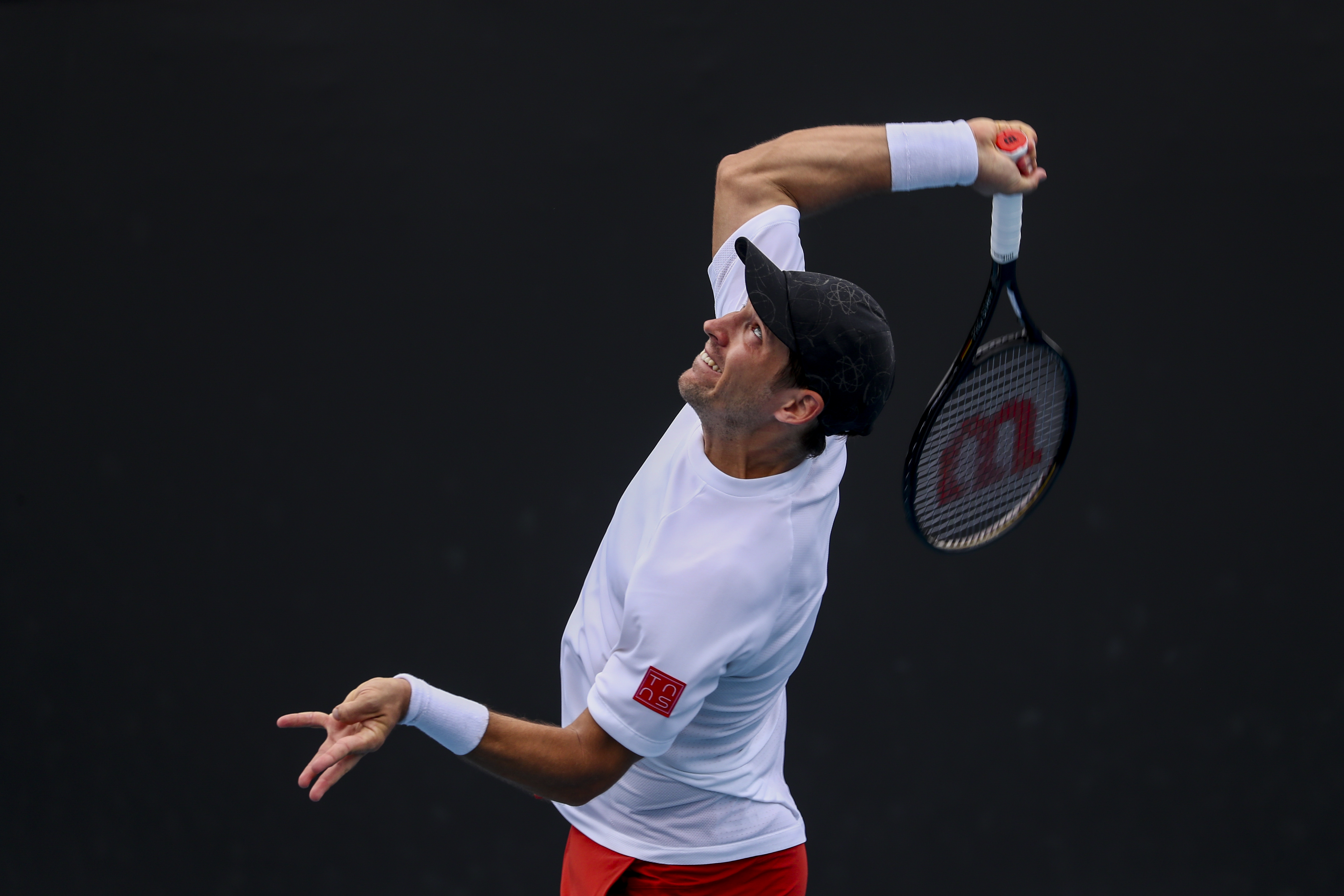 epa09690418 Dusan Lajovic of Serbia in action against Marton Fucsovics of Hungary during their first round match at the Australian Open Grand Slam tennis tournament in Melbourne, Australia, 17 January 2022.  EPA-EFE/JASON O'BRIEN