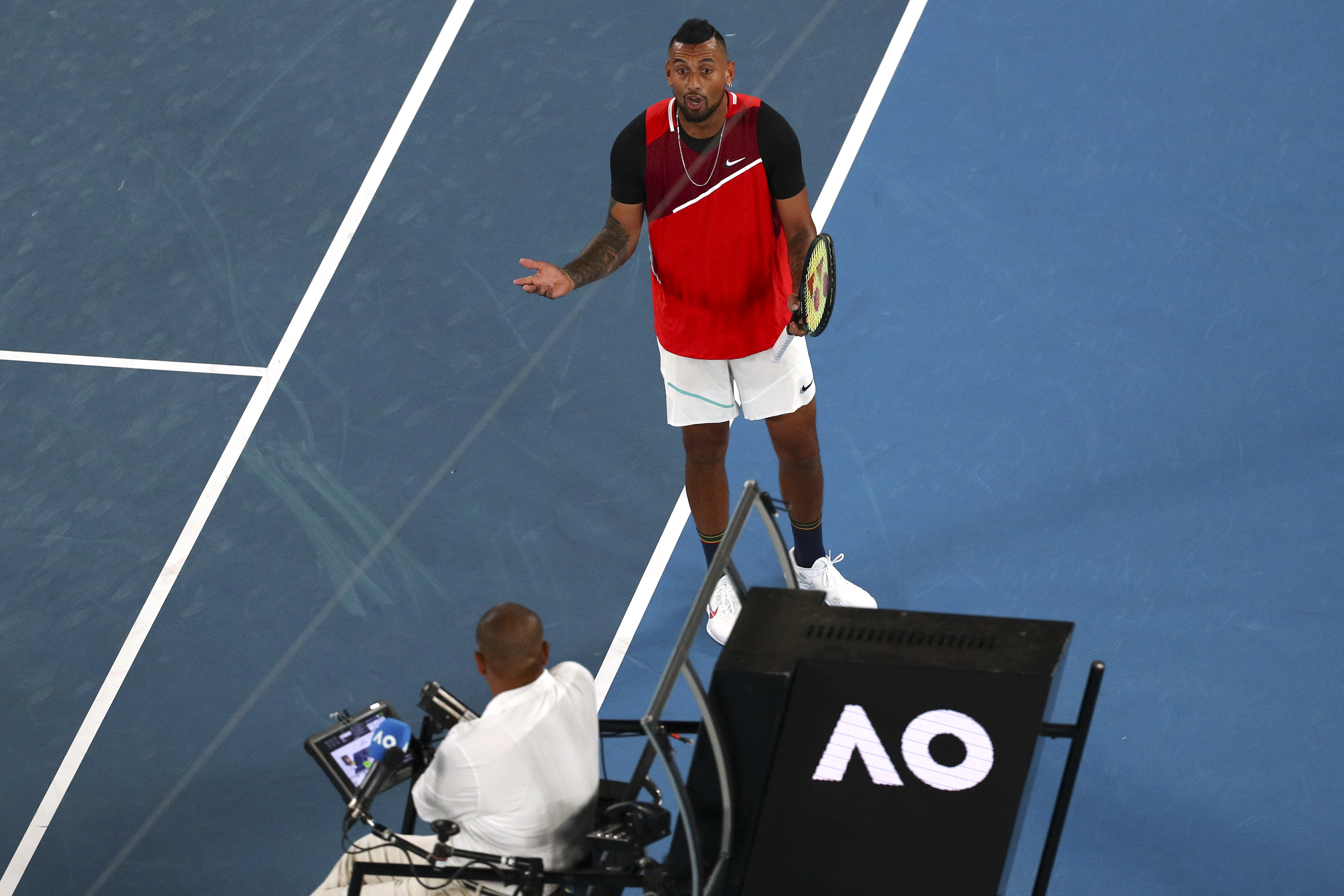 Nick Kyrgios of Australia argues with chair umpire Damien Dumusois during his second match against Daniil Medvedev of Russia at the Australian Open tennis championships in Melbourne, Australia, Thursday, Jan. 20, 2022. (AP Photo/Tertius Pickard)