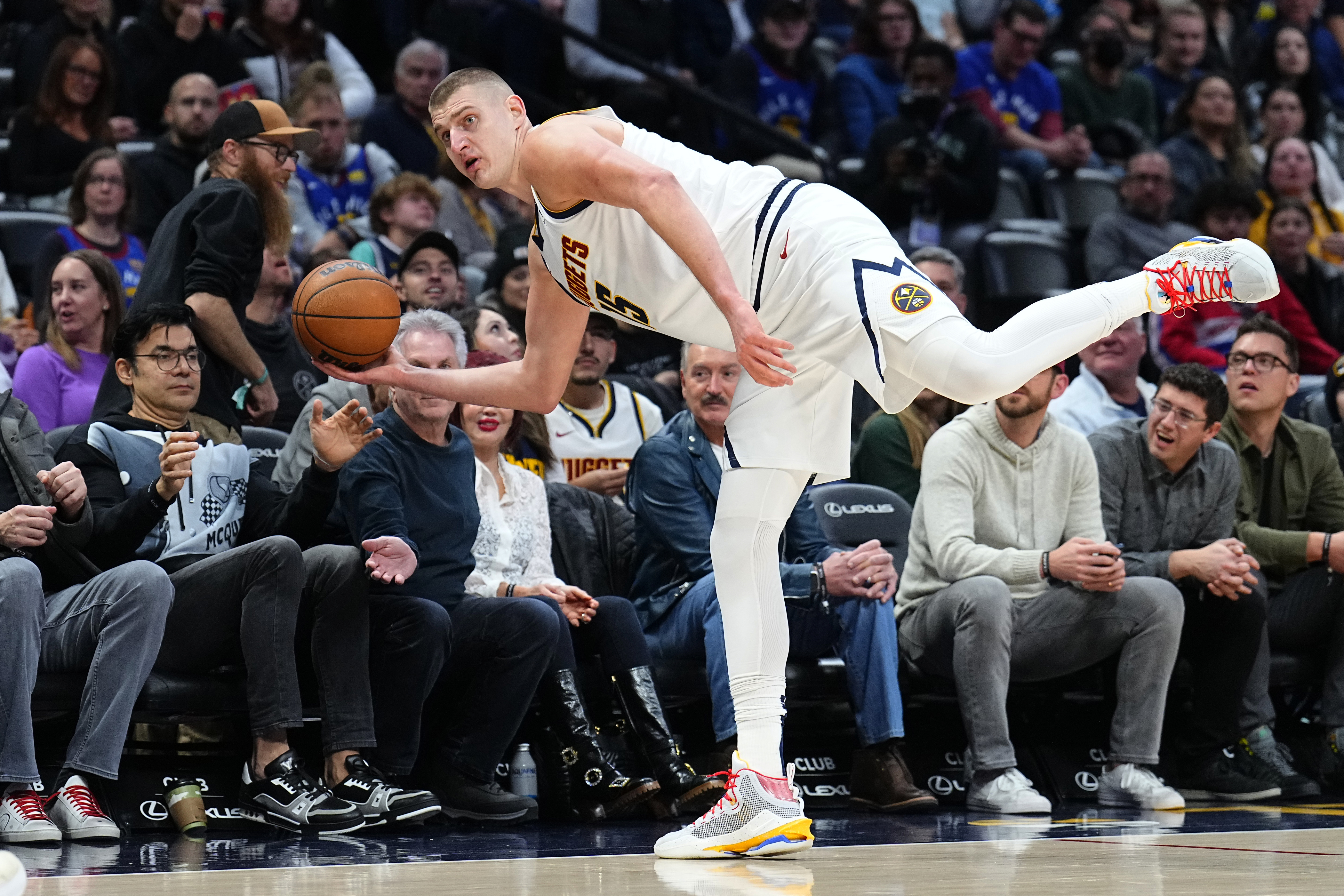 Denver Nuggets center Nikola Jokic (15) tries to save the ball from going out of bounds during the second half of the team's NBA basketball game against the Houston Rockets, Wednesday, Nov. 30, 2022, in Denver. (AP Photo/Jack Dempsey)
