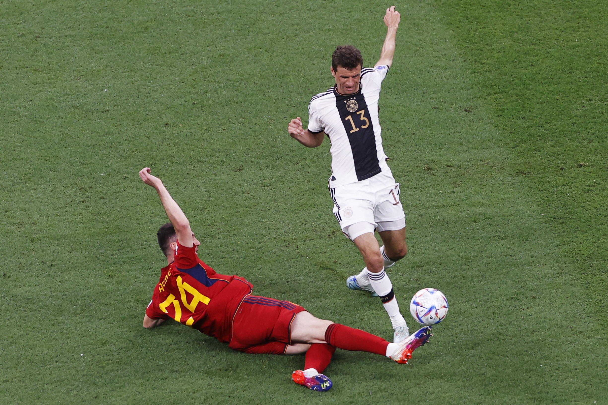 epa10333162 Thomas Muller of Germany (R) in action against Aymeric Laporte of Spain during the FIFA World Cup 2022 group E soccer match between Spain and Germany at Al Bayt Stadium in Al Khor, Qatar, 27 November 2022.  EPA-EFE/Rungroj Yongrit