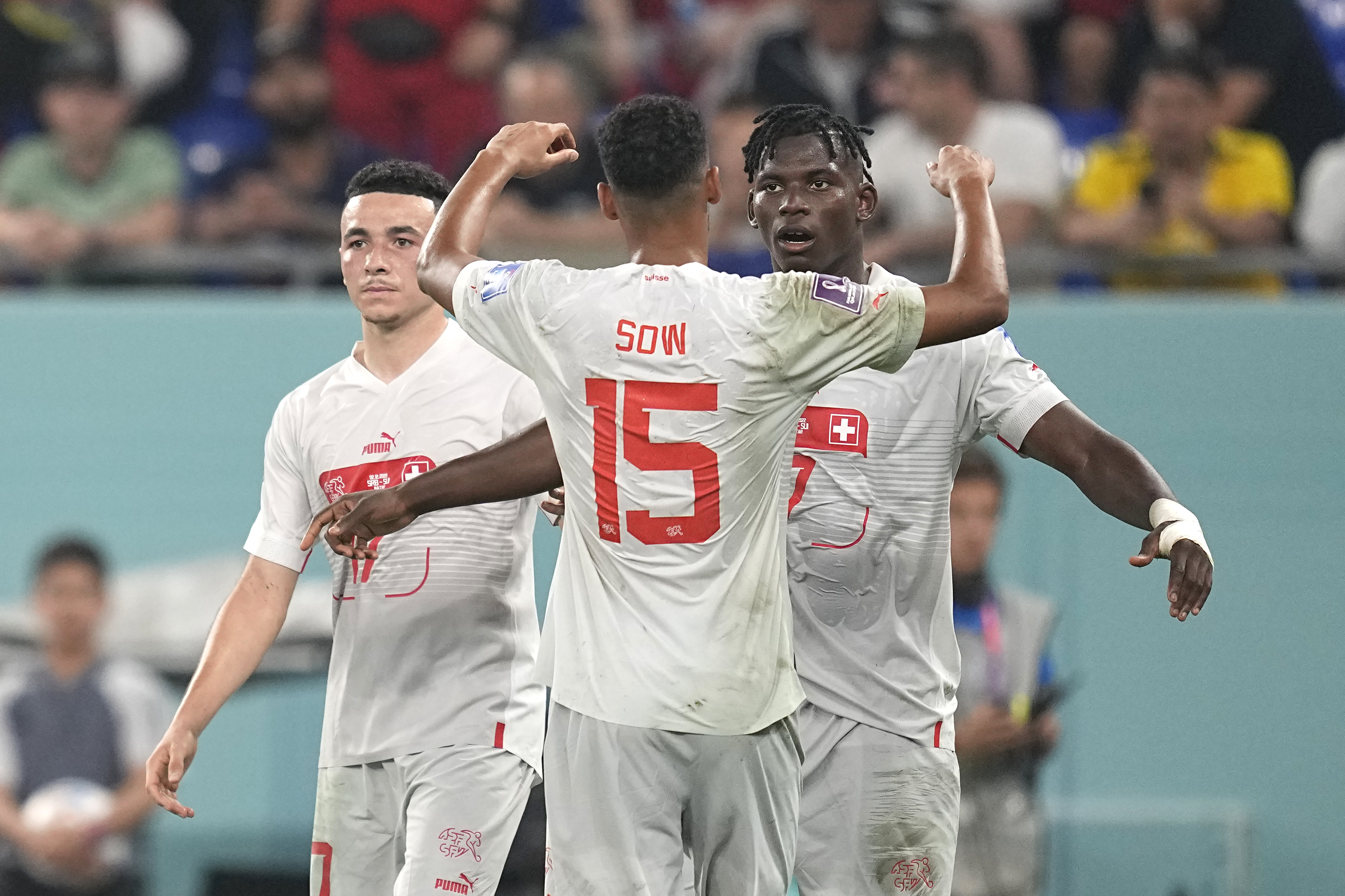 Switzerland's Breel Embolo, right, celebrates after scoring his side's second goal during the World Cup group G soccer match between Serbia and Switzerland, at the Stadium 974 in Doha, Qatar, Friday, Dec. 2, 2022. (AP Photo/Ebrahim Noroozi)