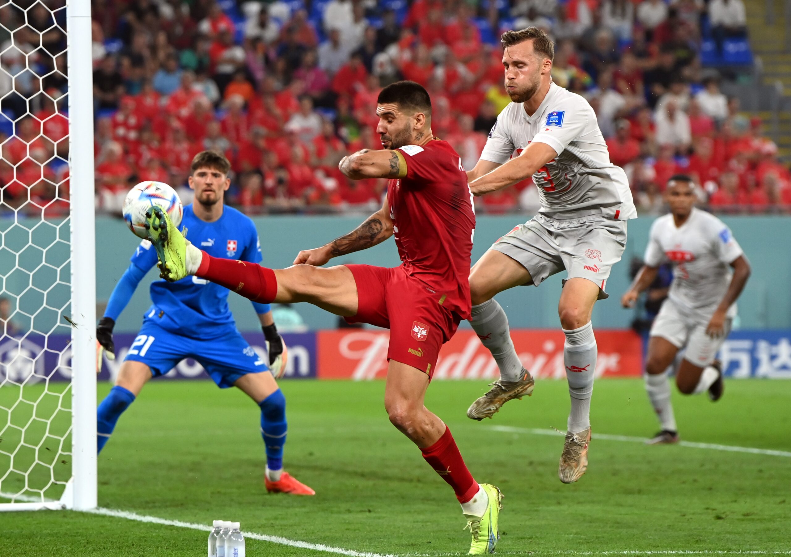 epa10345151 Aleksandar Mitrovic (C) of Serbia in action against Silvan Widmer of Switzerland during the FIFA World Cup 2022 group G soccer match between Serbia and Switzerland at Stadium 947 in Doha, Qatar, 02 December 2022.  EPA-EFE/Georgi Licovski