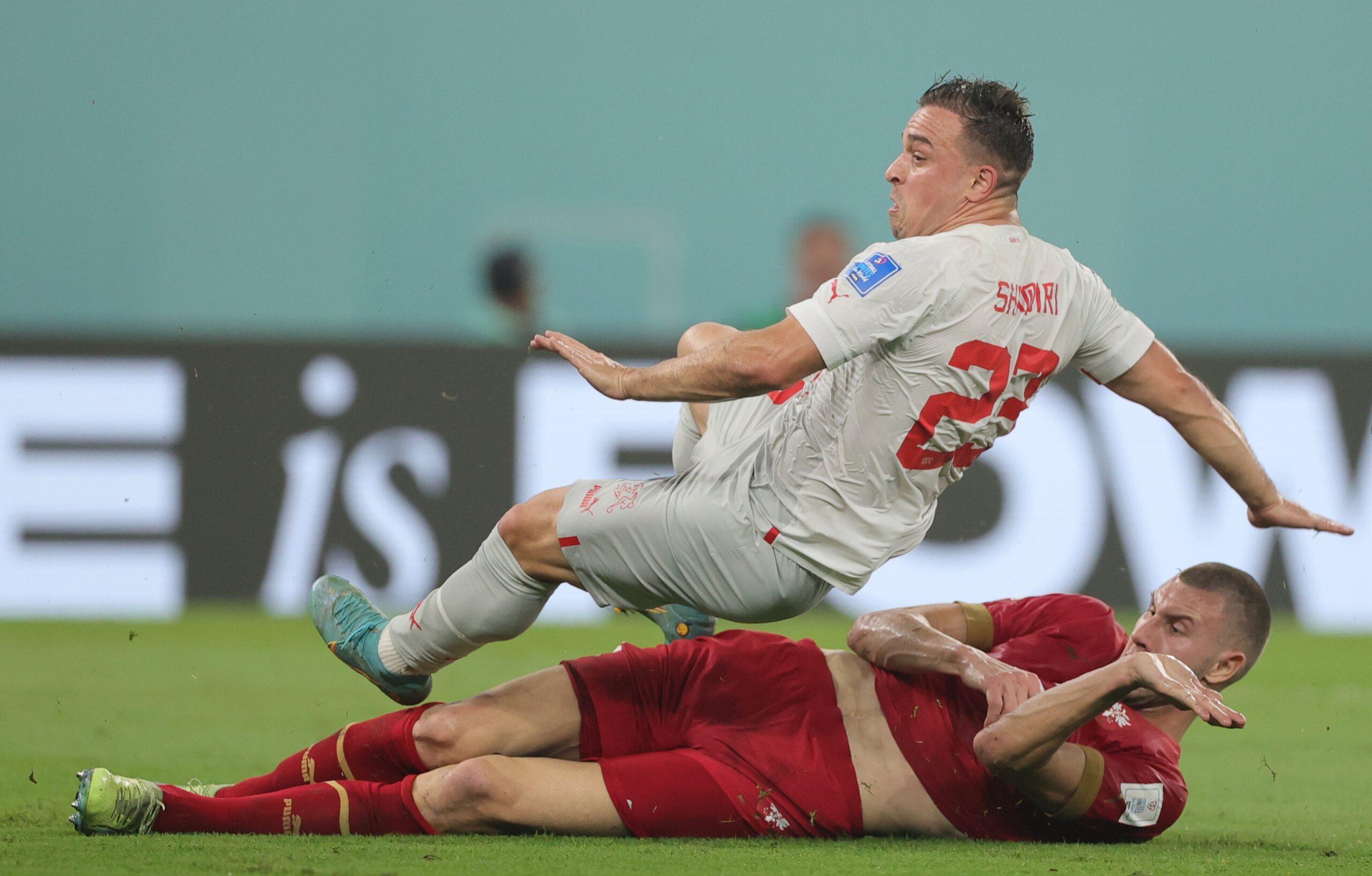 epa10345046 Strahinja Pavlovic (down) of Serbia in action against Xherdan Shaqiri of Switzerland during the FIFA World Cup 2022 group G soccer match between Serbia and Switzerland at Stadium 947 in Doha, Qatar, 02 December 2022.  EPA-EFE/Friedemann Vogel