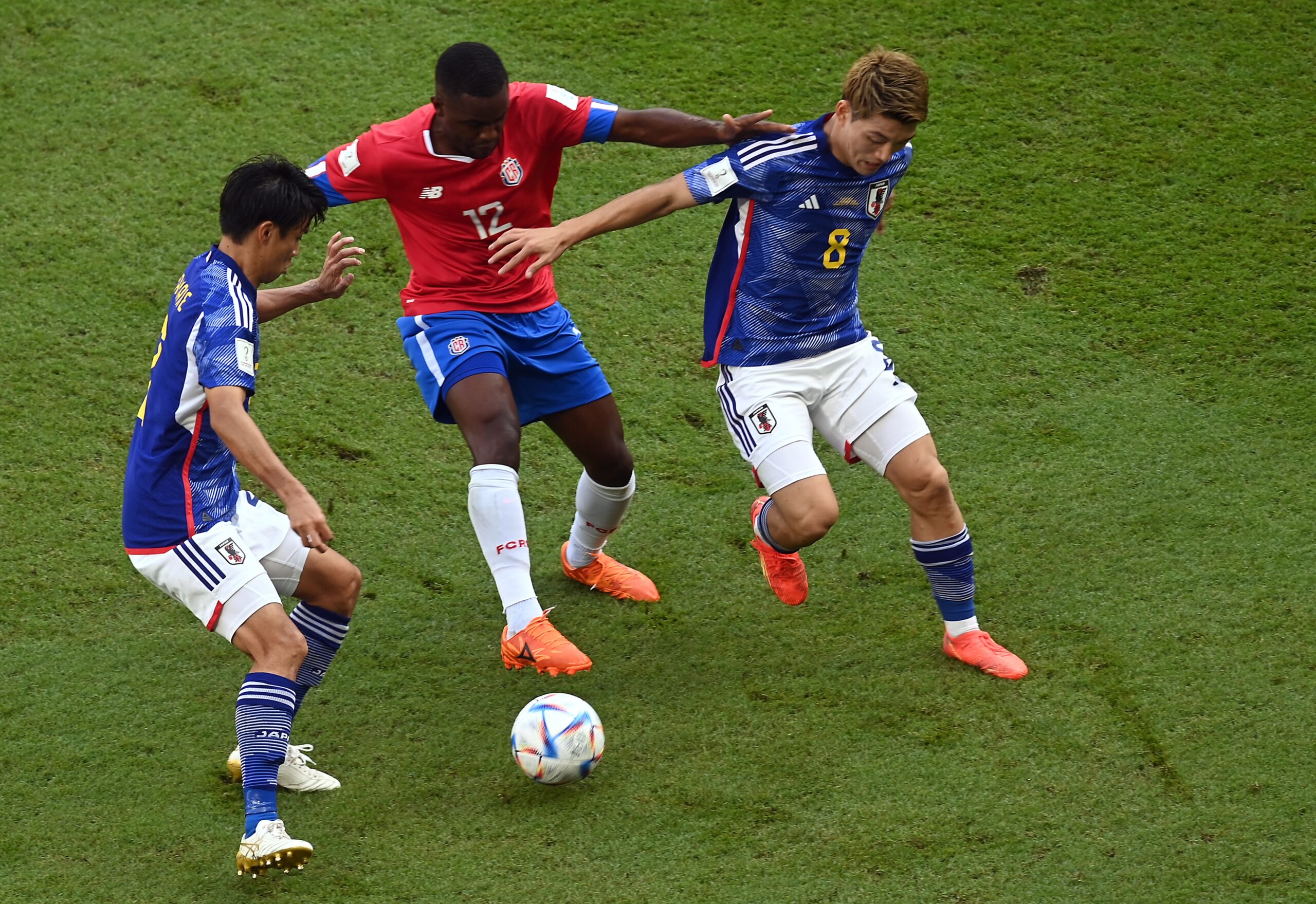 epa10331654 Ritsu Doan (R) of Japan in action against Joel Campbell (C) of Costa Rica during the FIFA World Cup 2022 group E soccer match between Japan and Costa Rica at Ahmad bin Ali Stadium in Doha, Qatar, 27 November 2022.  EPA-EFE/Neil Hall